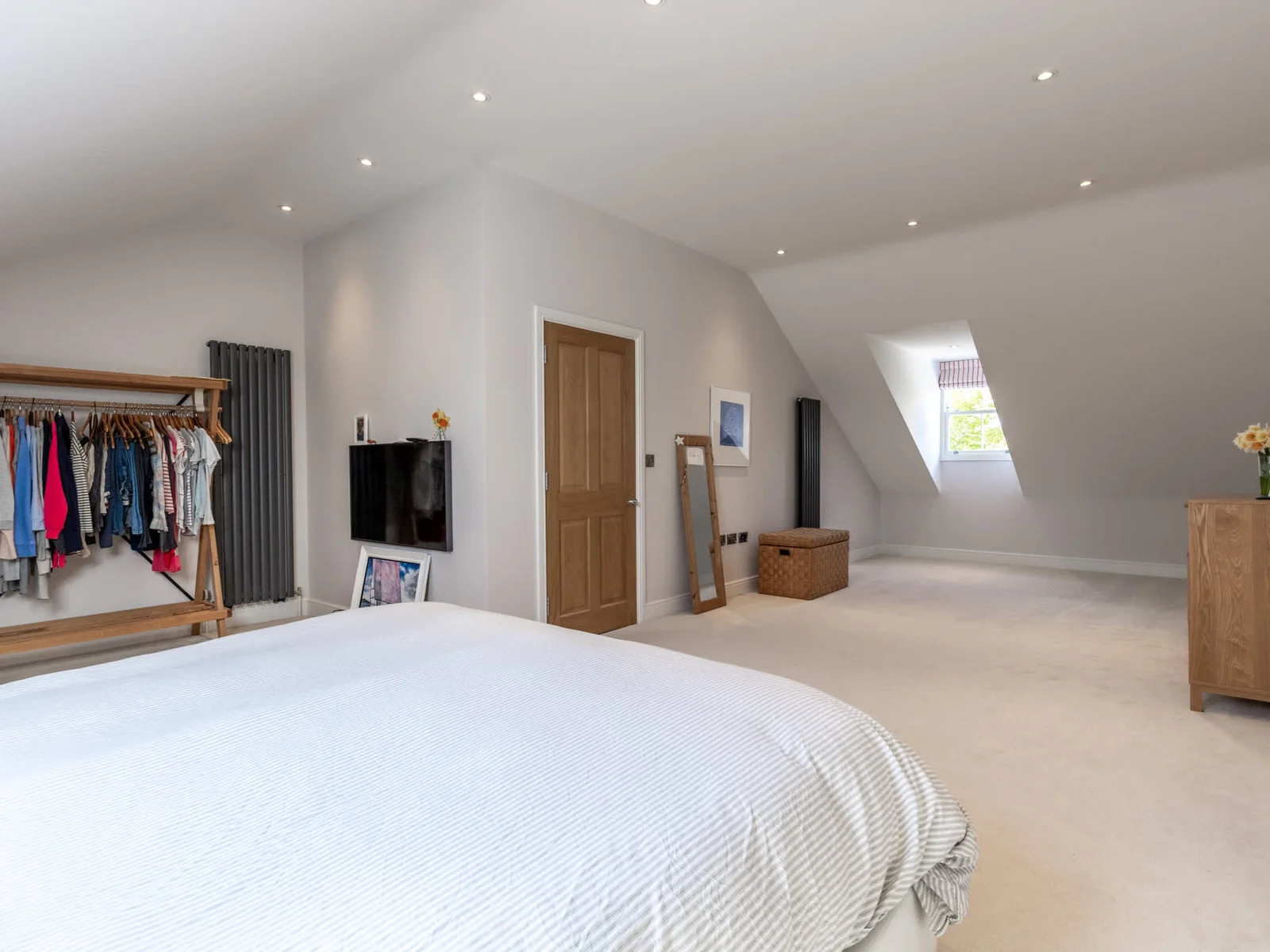 Large master bedroom with vaulted ceilings, skylight and generous floor space.