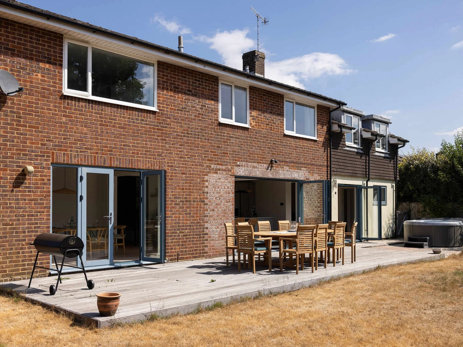Designed for effortless outdoor living, the spacious deck brings together alfresco dining, a BBQ and private hot tub, opening seamlessly onto the generous lawn beyond.