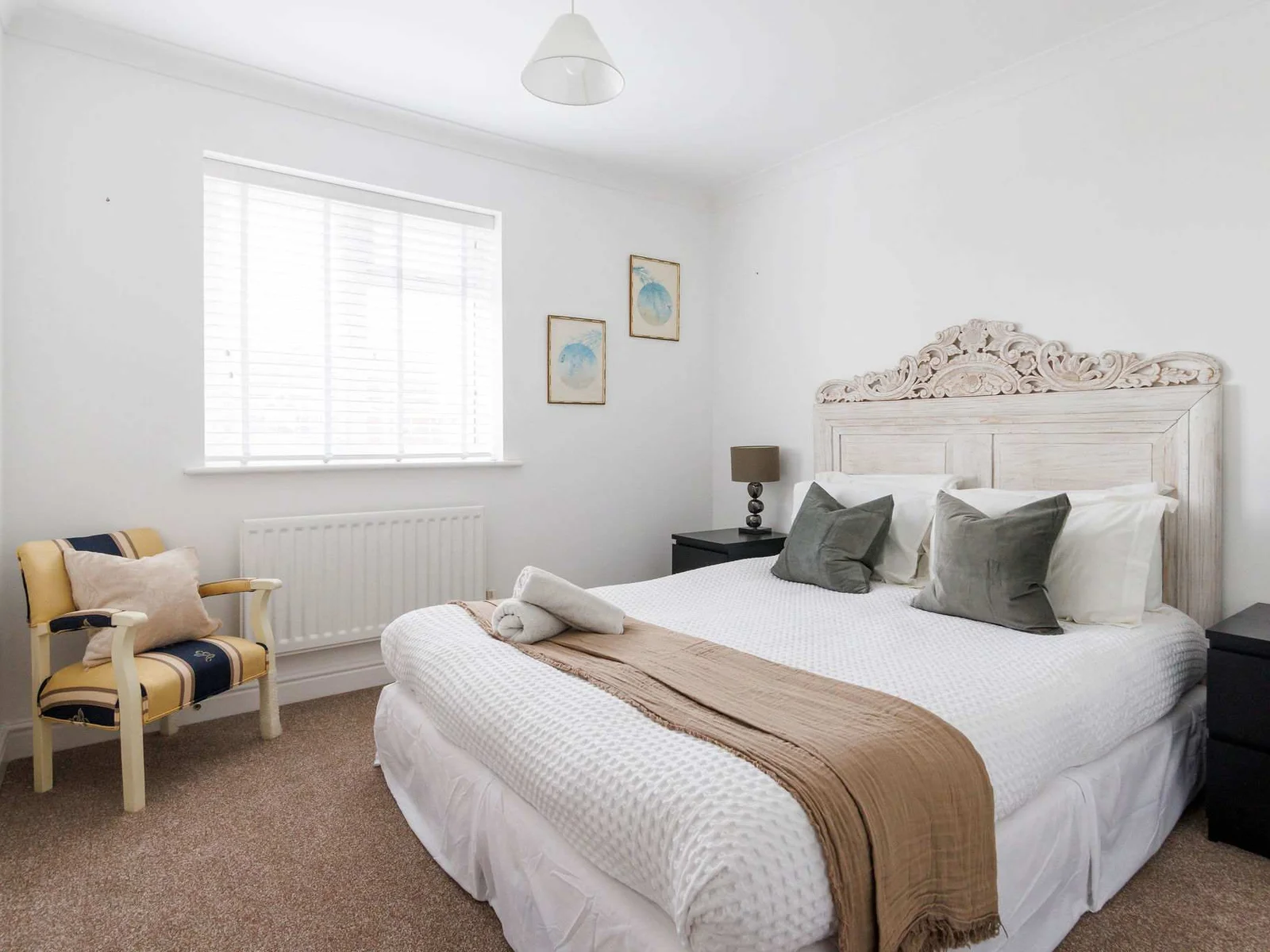 Bedroom 2 has a comfy king bed with side tables and reading lamps.