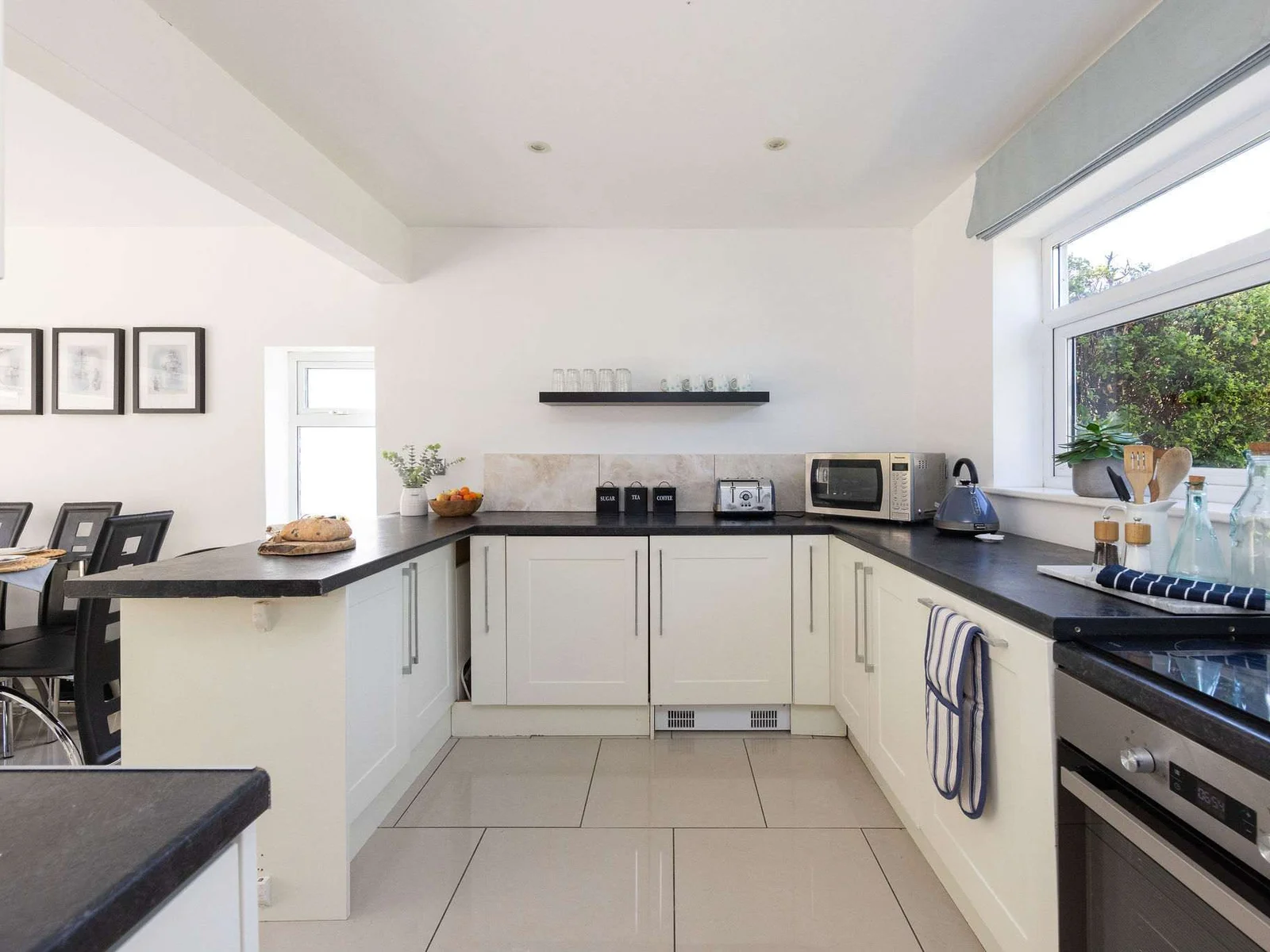 Prepare meals in the modern, fully equipped kitchen of this bright family getaway property.
