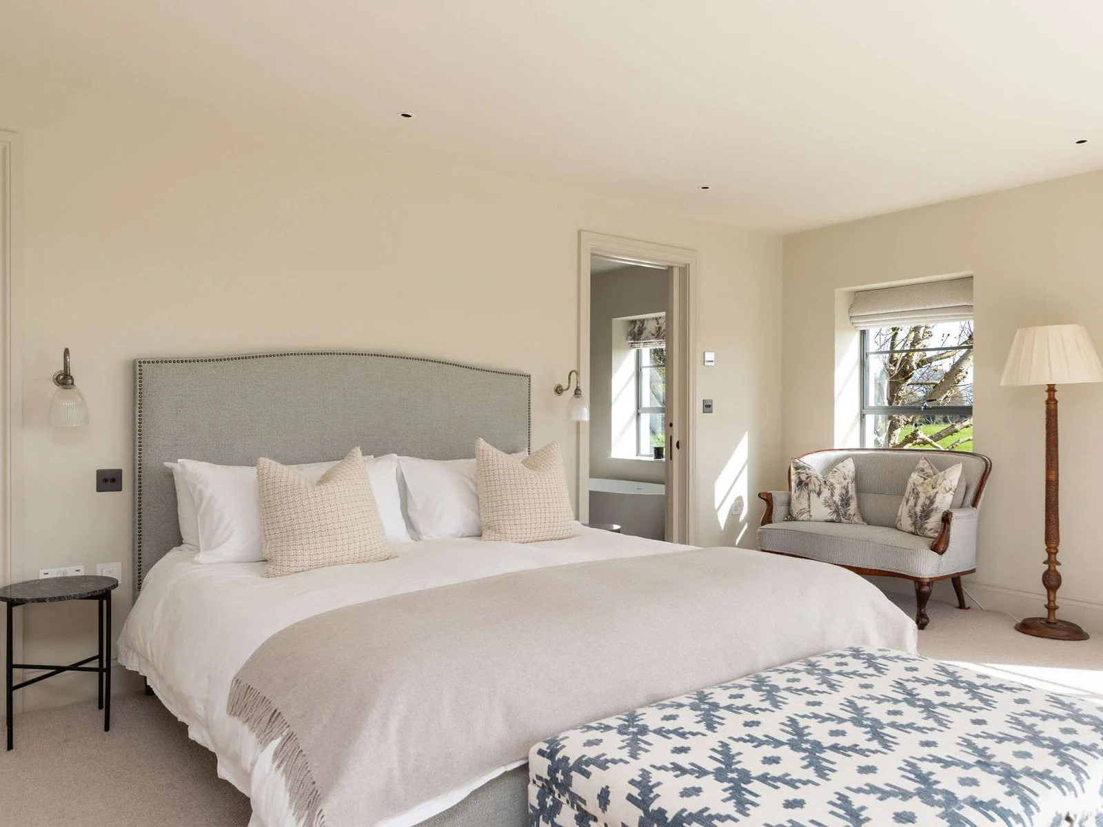 Restful king bedroom with plush bedding and soft furnishings for a truly peaceful stay.