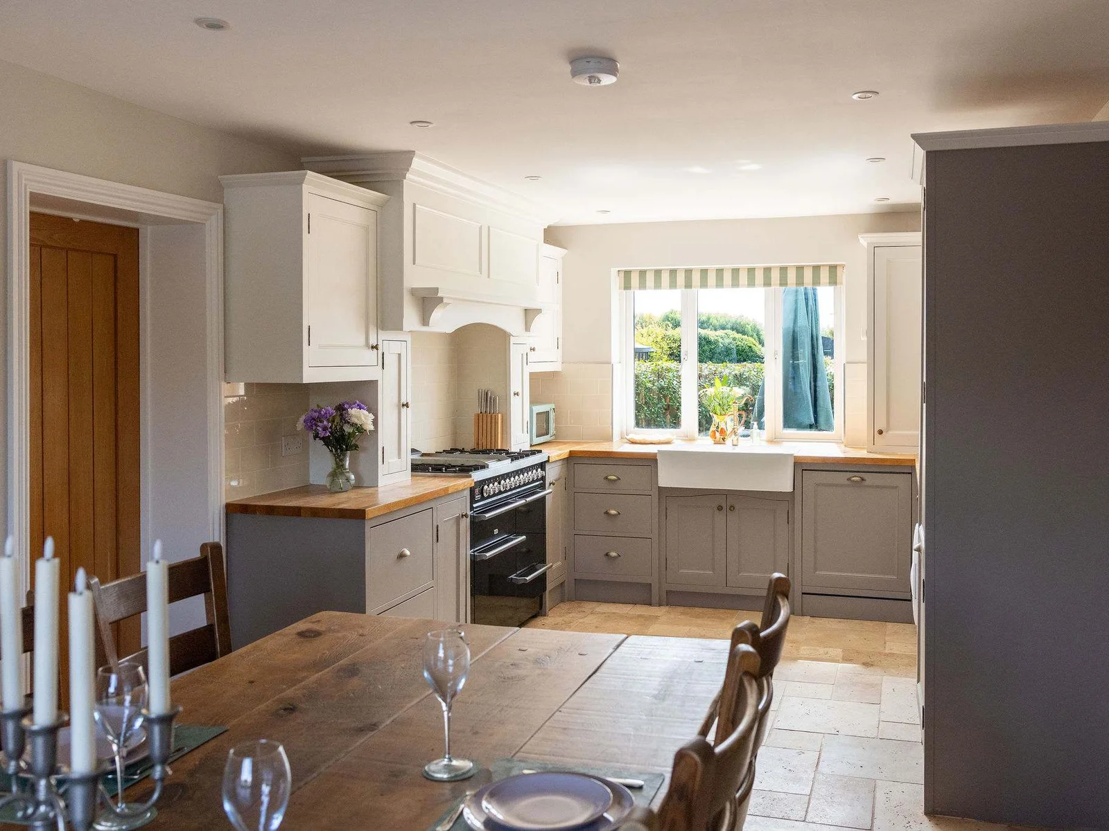 A bright and welcoming kitchen-dining space with a large range cooker, warm natural finishes and everything you need for your stay — all combining to give the home a lovely, homely country-house feel.