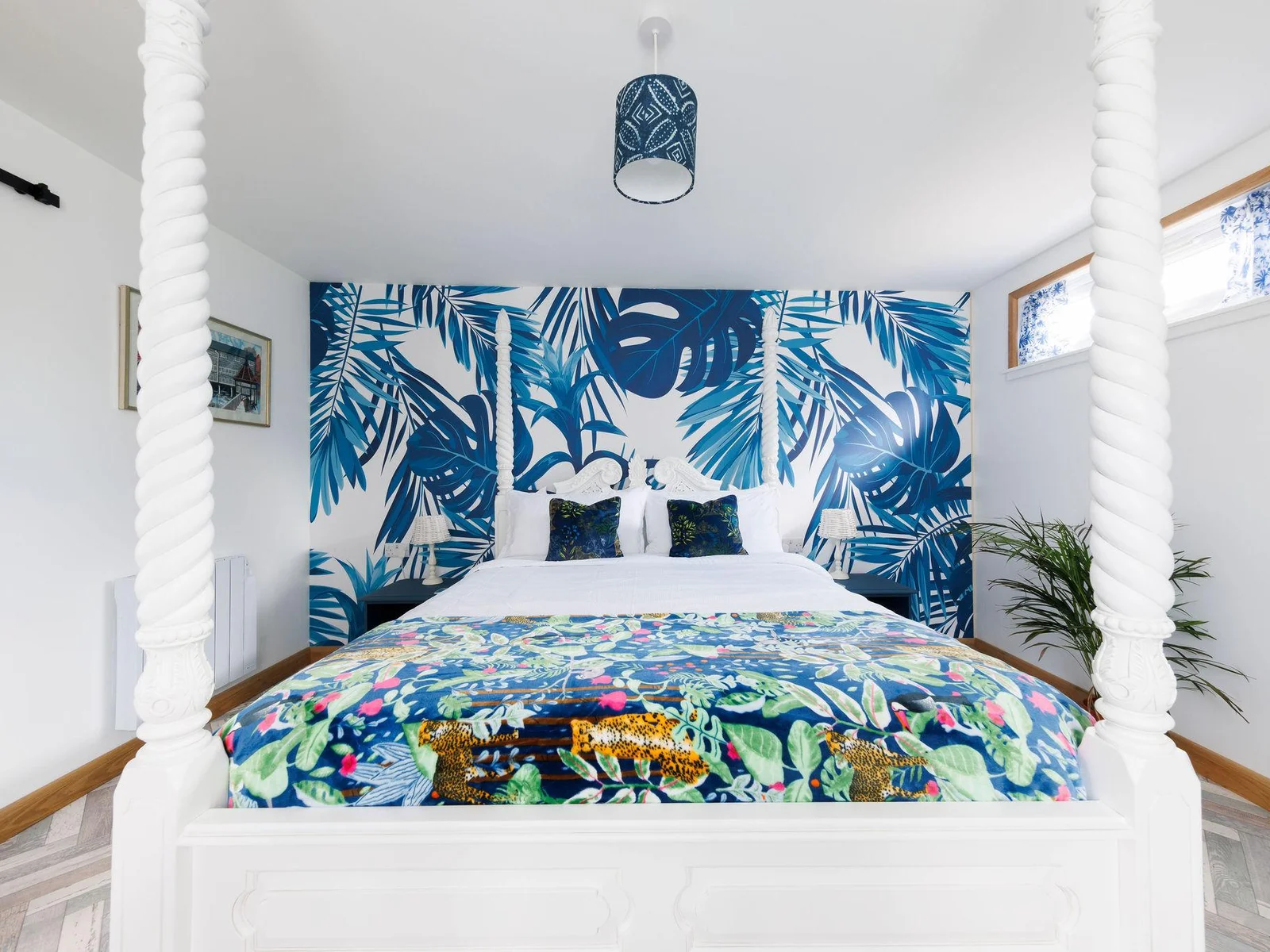The feature wall really adds character creating a warm and inviting atmosphere, especially when paired with a comfy king bed.