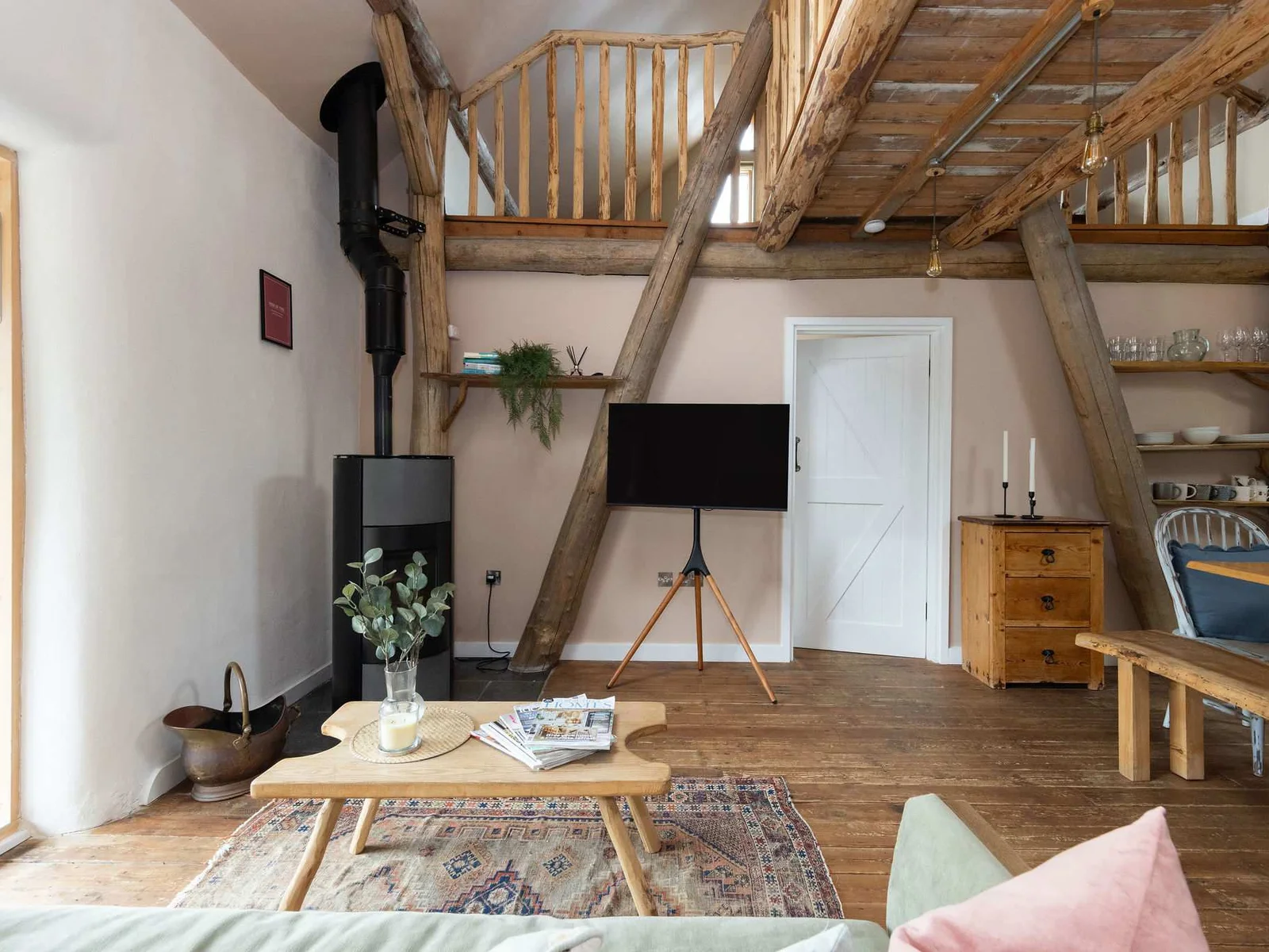Open-plan living with rustic timber beams — a warm and sociable space to gather.