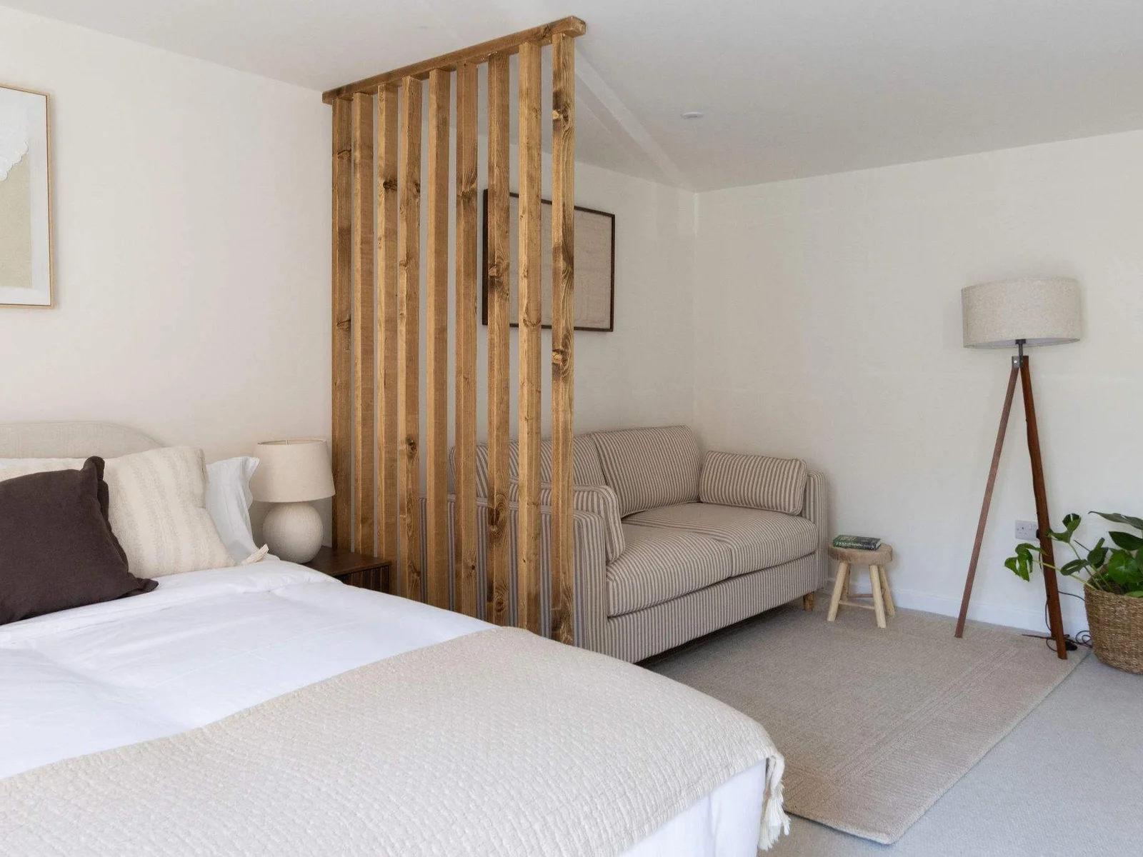 Comfortable king bedroom with relaxing seating area, perfect for families or longer holiday stays.