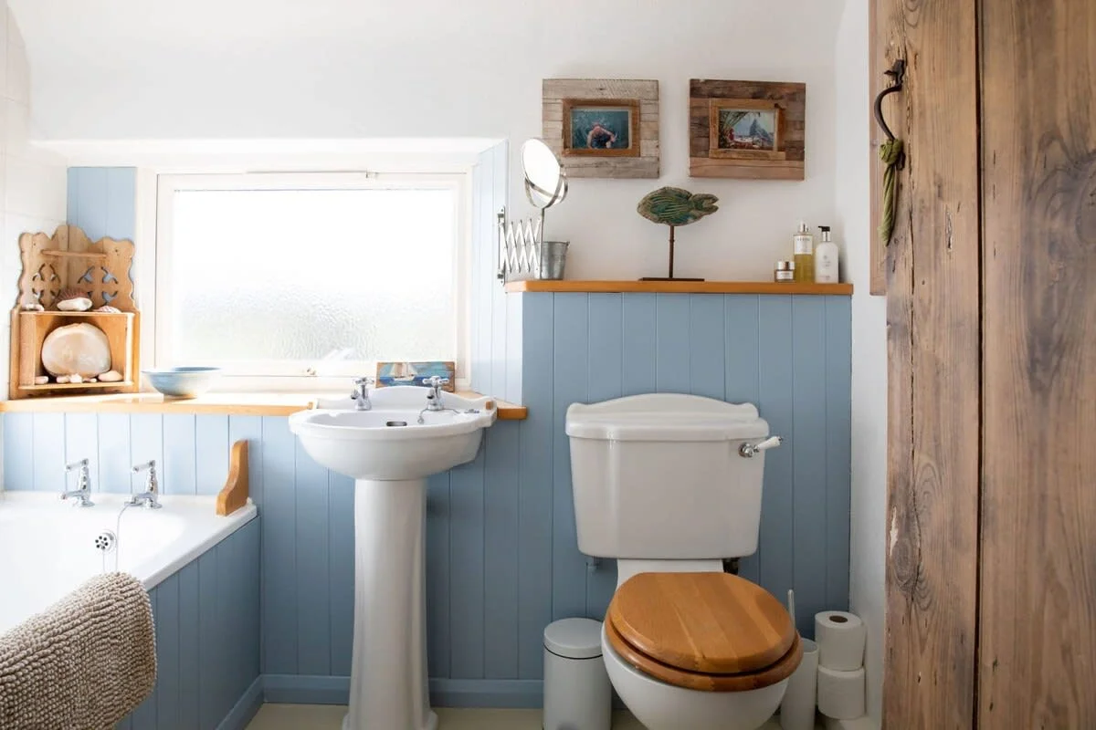 The full family bathroom has a bath, overhead shower, sink and WC.