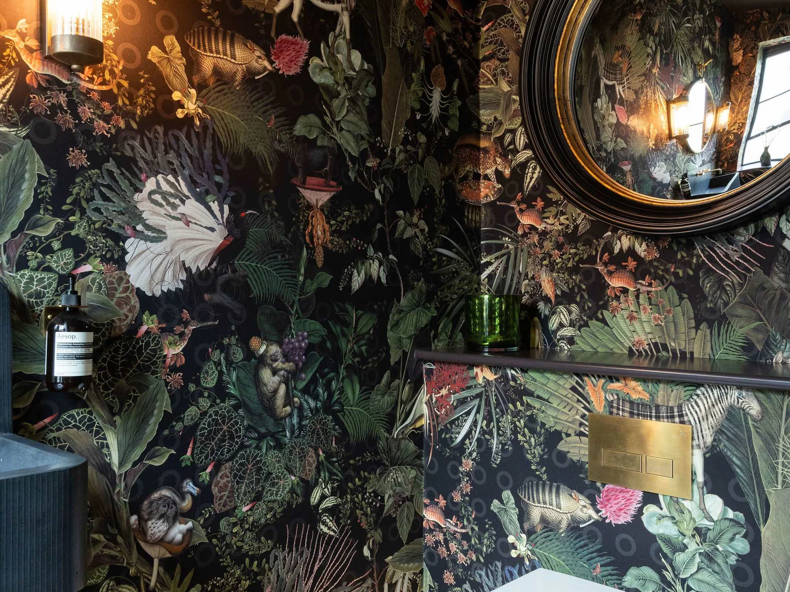 Every corner is beautifully designed — bold wallpaper and gold mirror create a memorable impression.