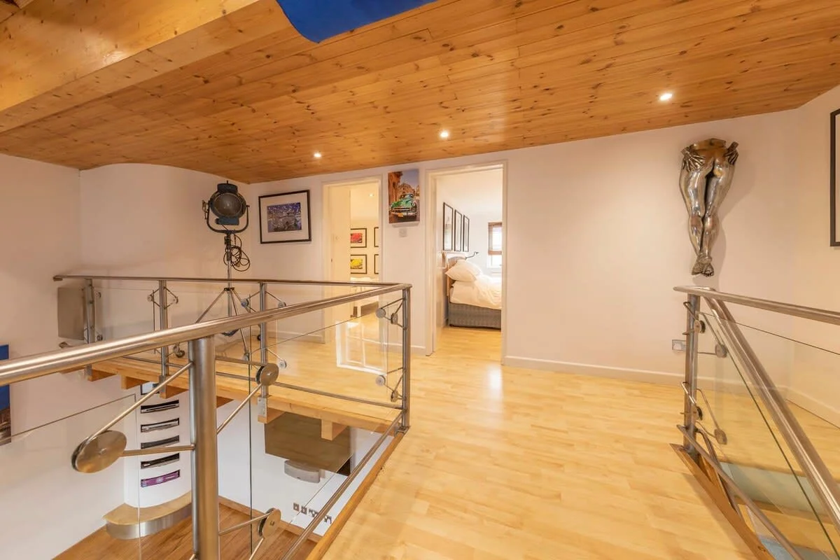 The bright and spacious upstairs landing flows through to the bedrooms.