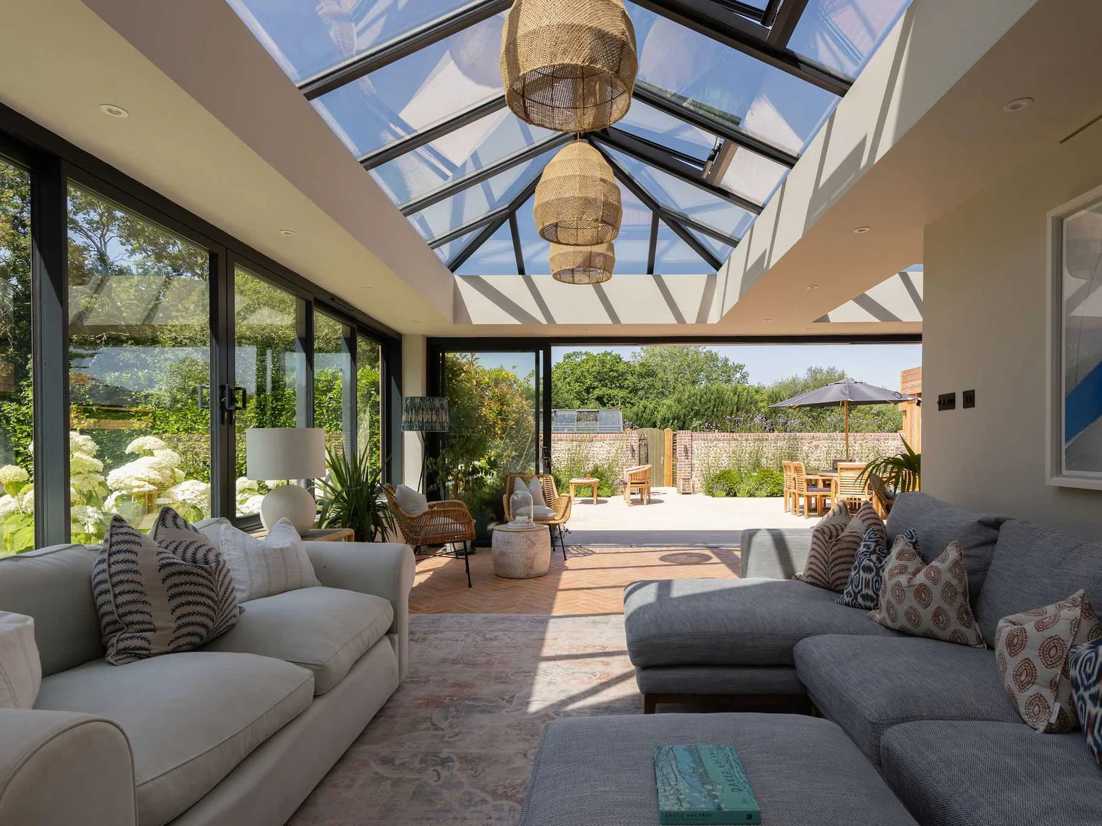 Sun-filled conservatory with plush seating and seamless access to the spacious garden terrace
