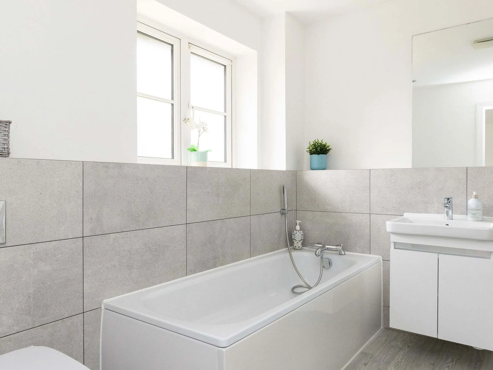 The modern and bright en-suite, complete with a full-size bathtub for a relaxing soak after a day of exploring.