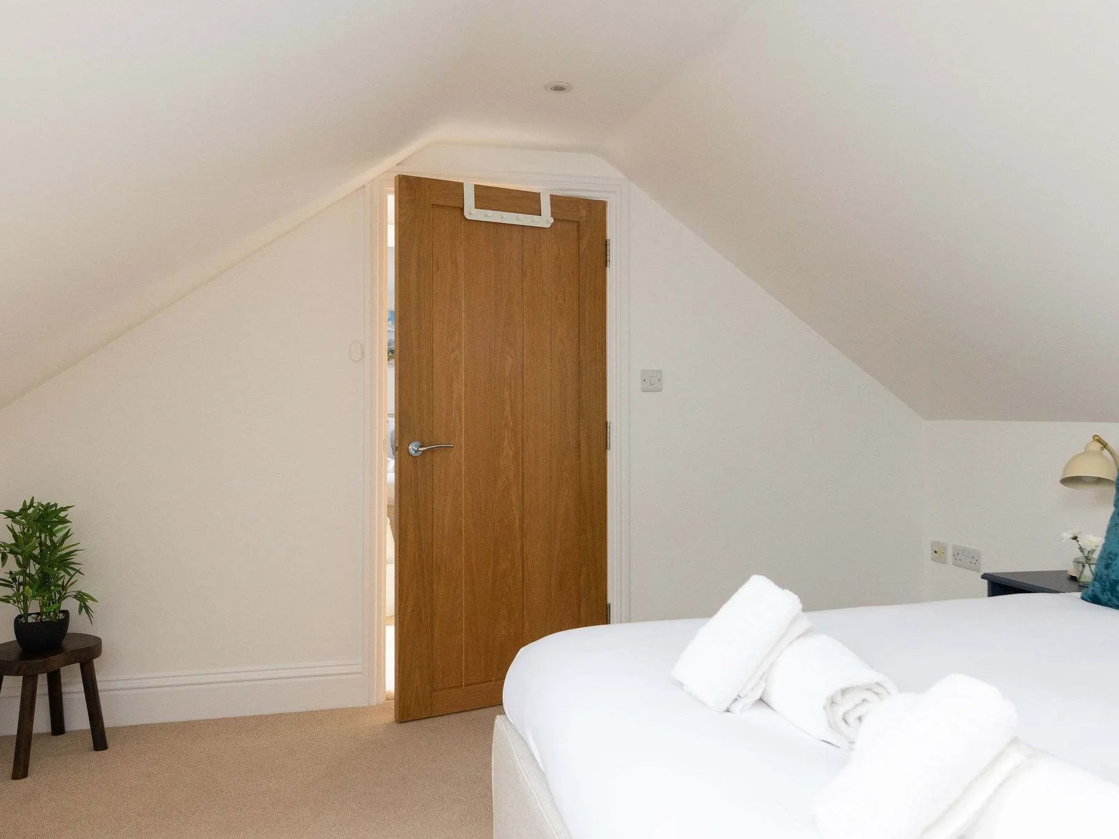 A spacious top-floor double, with sloped ceilings adding character without compromising on room — there’s plenty of space around the bed, giving the room an open and comfortable feel.