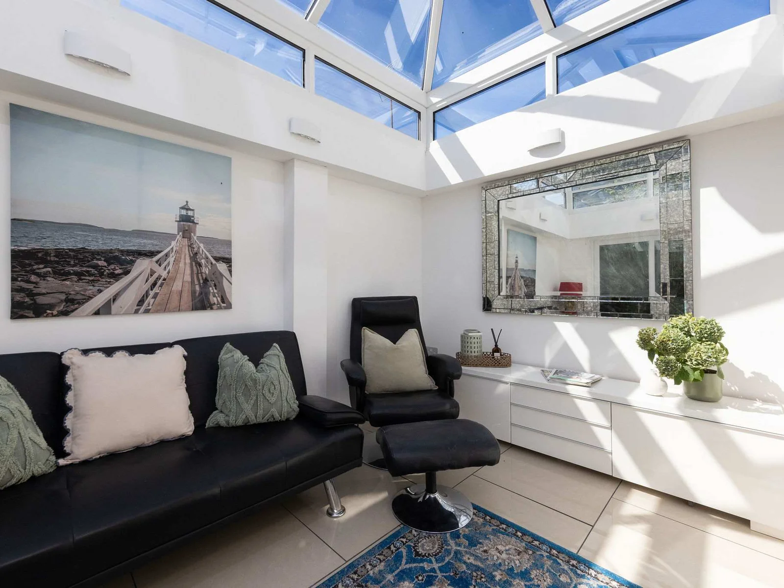 Unwind in the beautifully bright conservatory of this coastal retreat during your relaxing holiday.