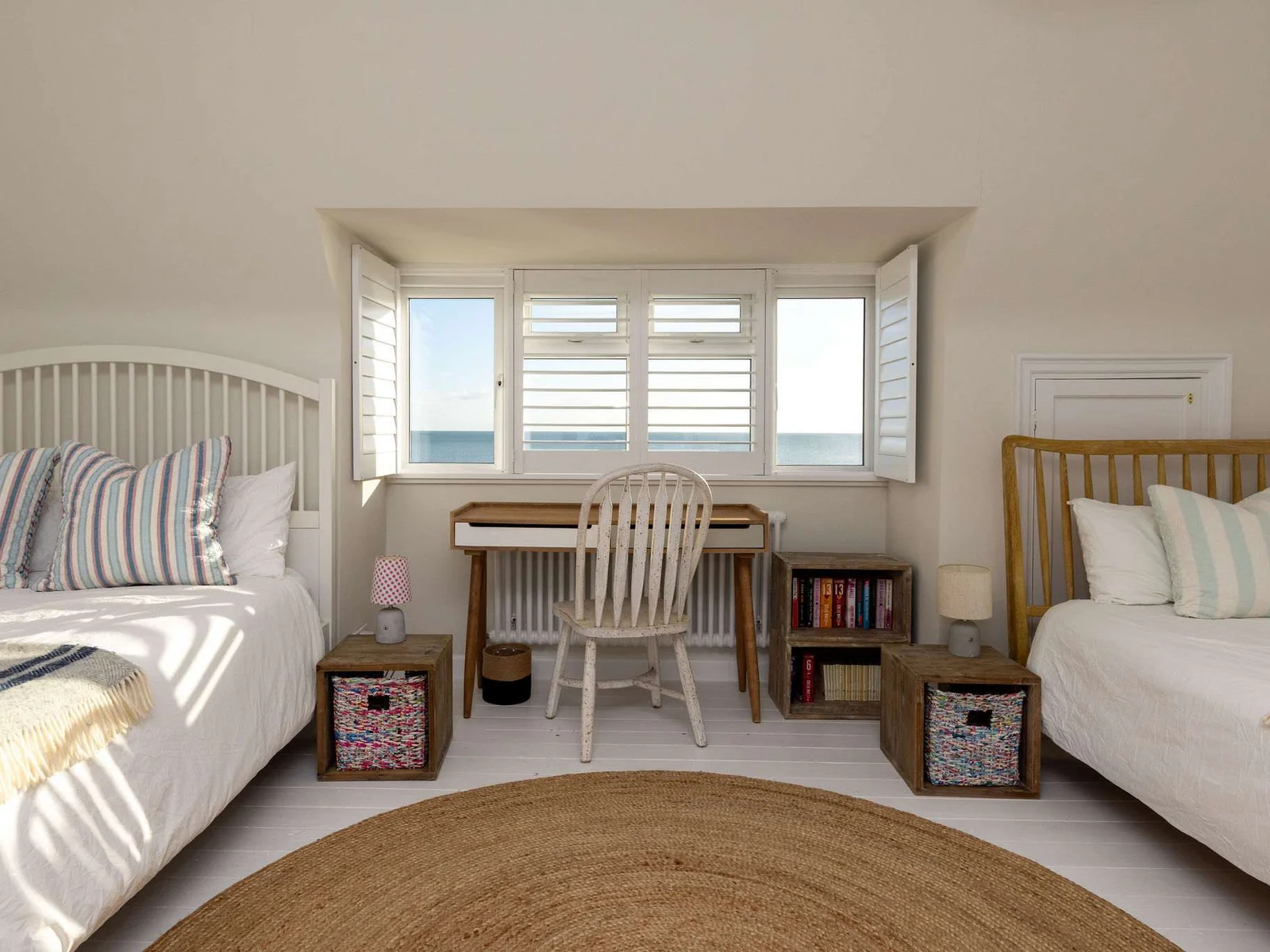 Bright twin room with workspace & views.