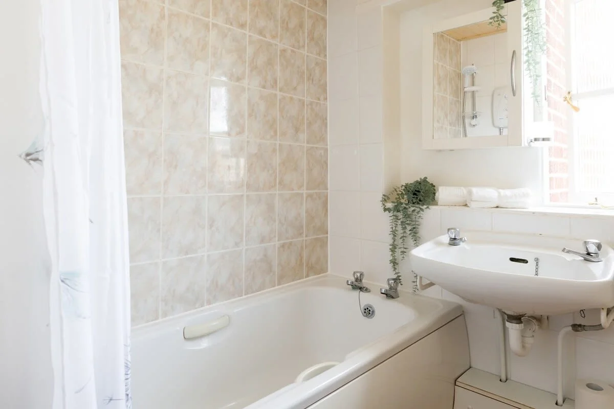 The spacious family bathroom is well stocked with towels and essential toiletries to freshen up after a day out and about.