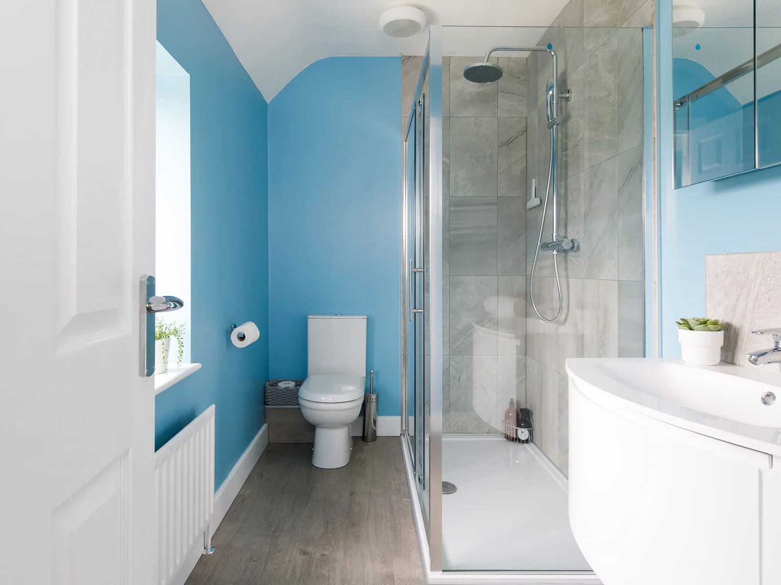 The master bedroom has a bright ensuite, with spacious walk-in shower, sink and WC.