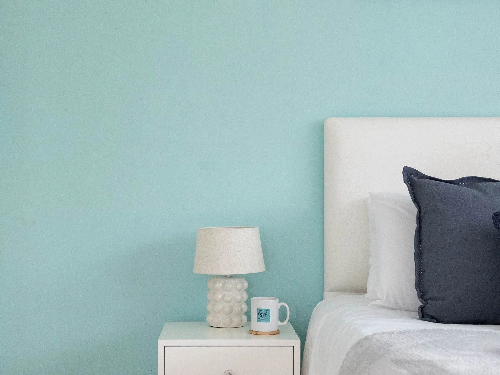 Bright bedside space with soft lighting and handy storage for added comfort and convenience.