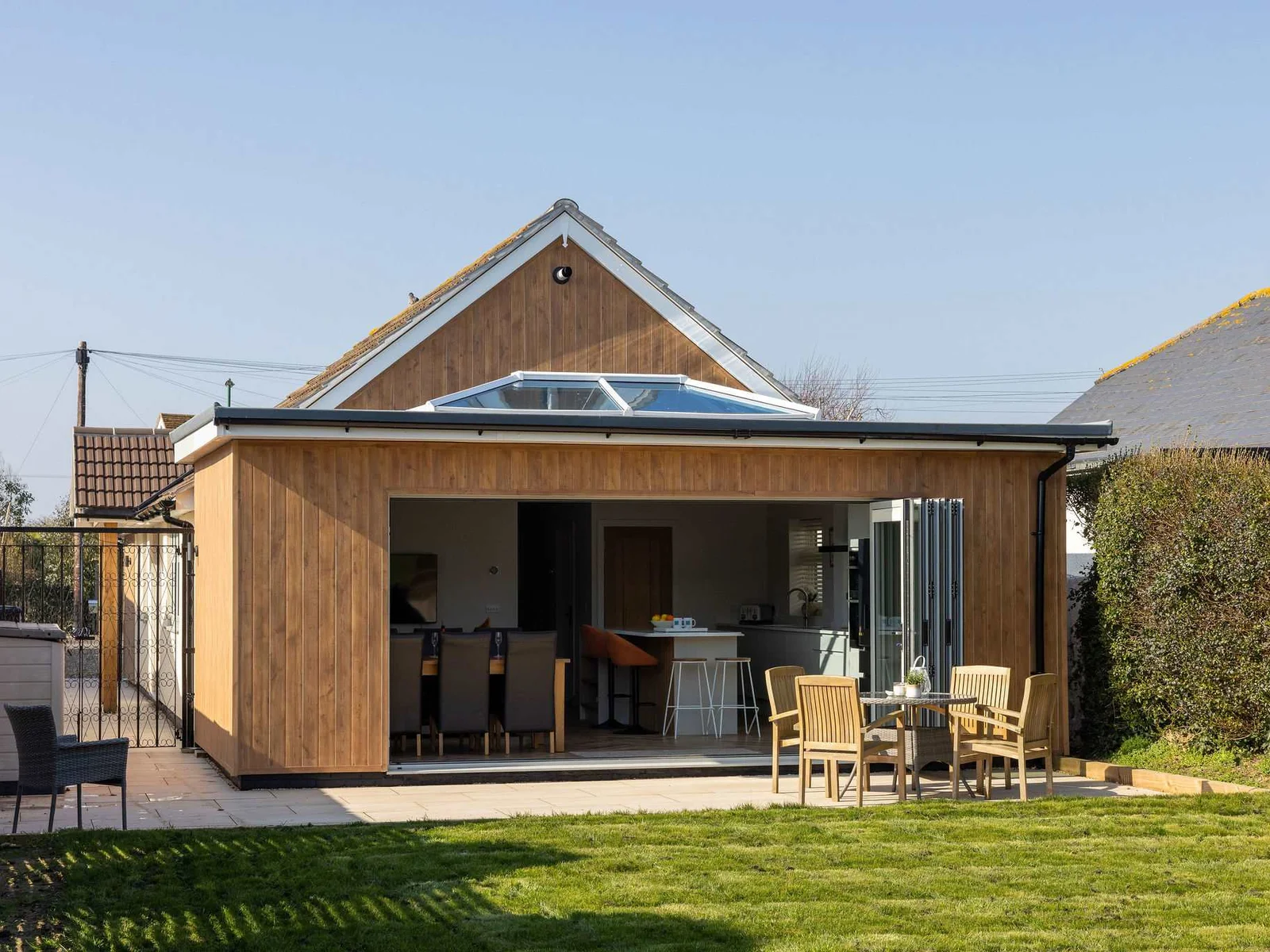 Stylish seaside home with private garden, perfect for outdoor dining and easy indoor-outdoor living.