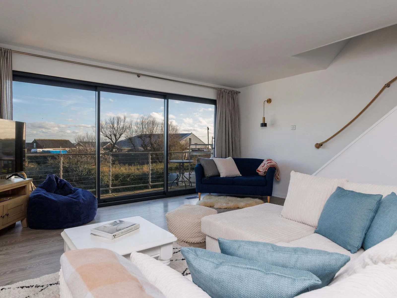 Living room opens to a balcony with peaceful outdoor views