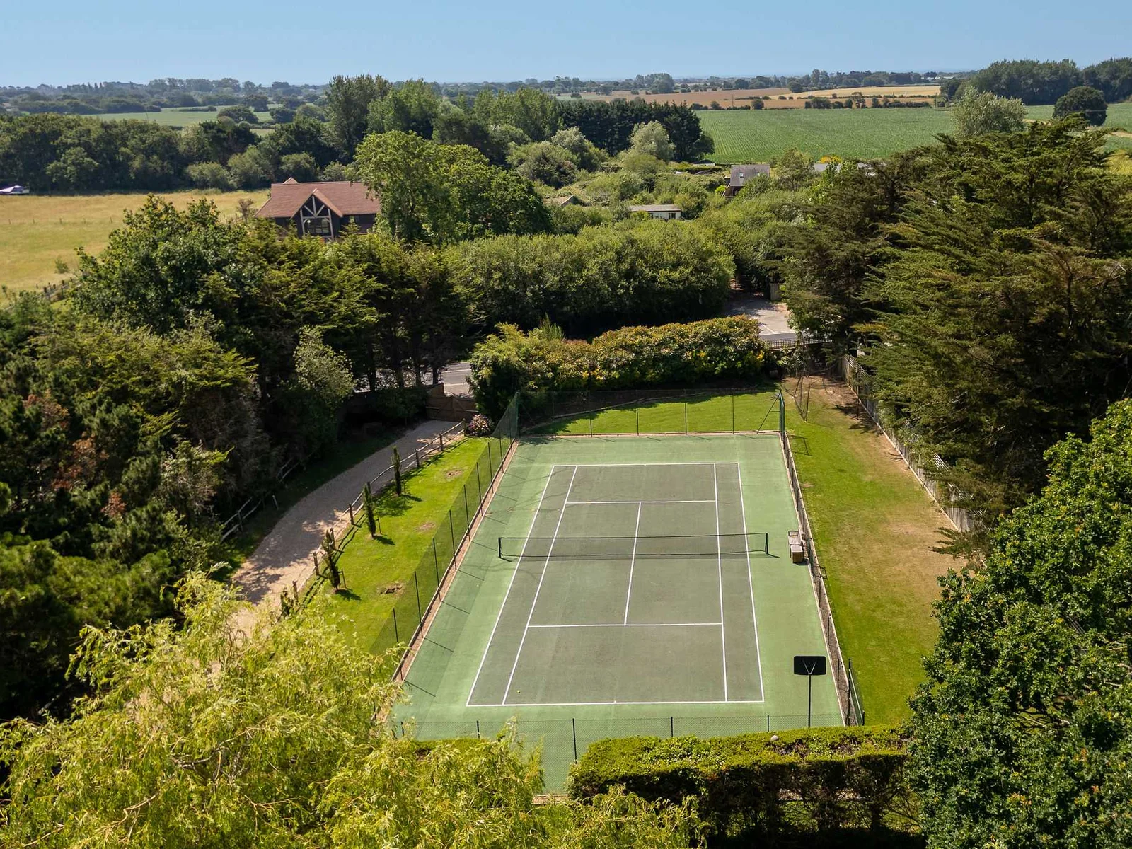 Private tennis court surrounded by scenic countryside, perfect for active family holidays and friendly matches