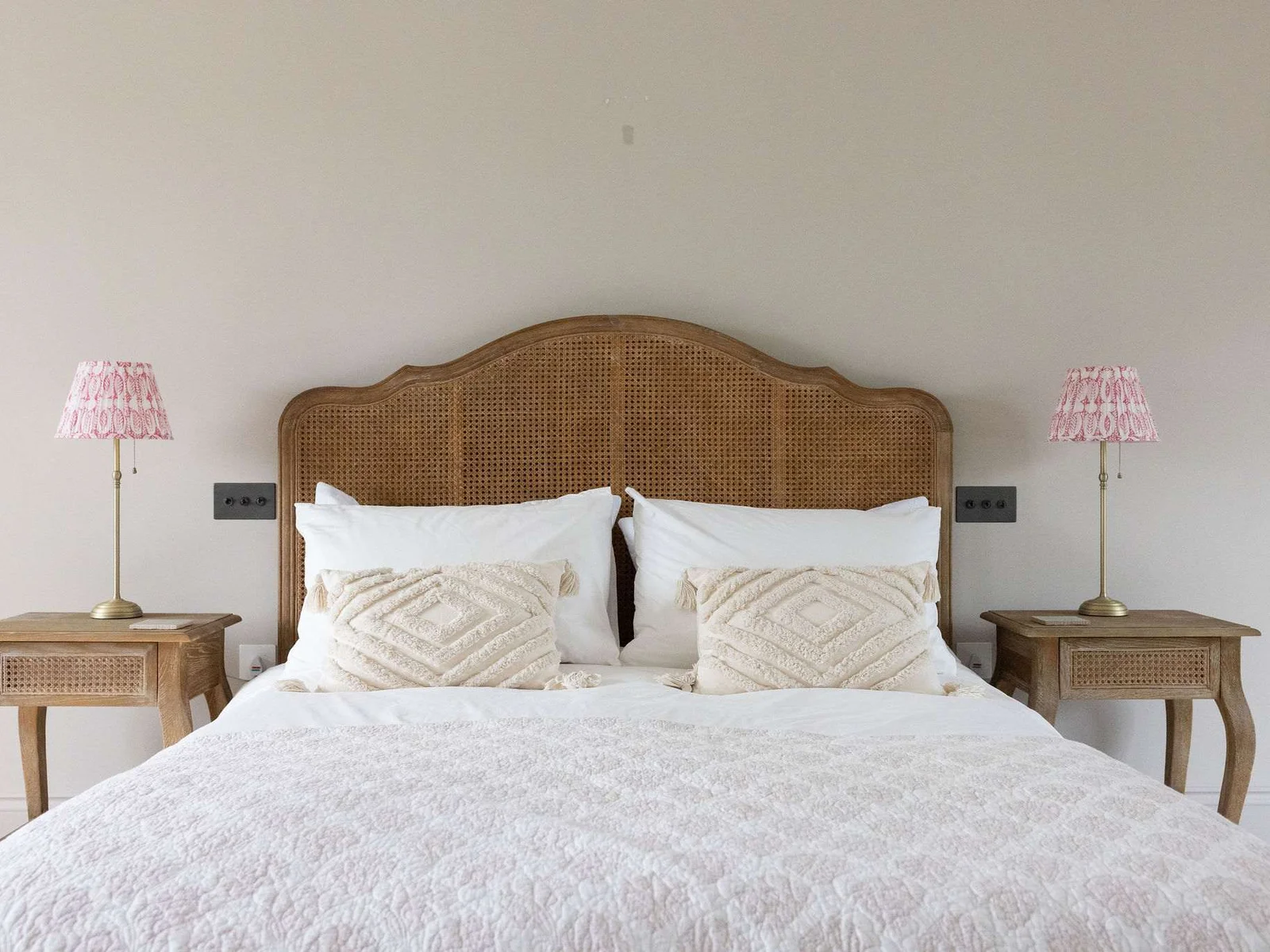 Beautiful attention to detail with textured cushions, elegant lamps, and a restful, inviting feel.