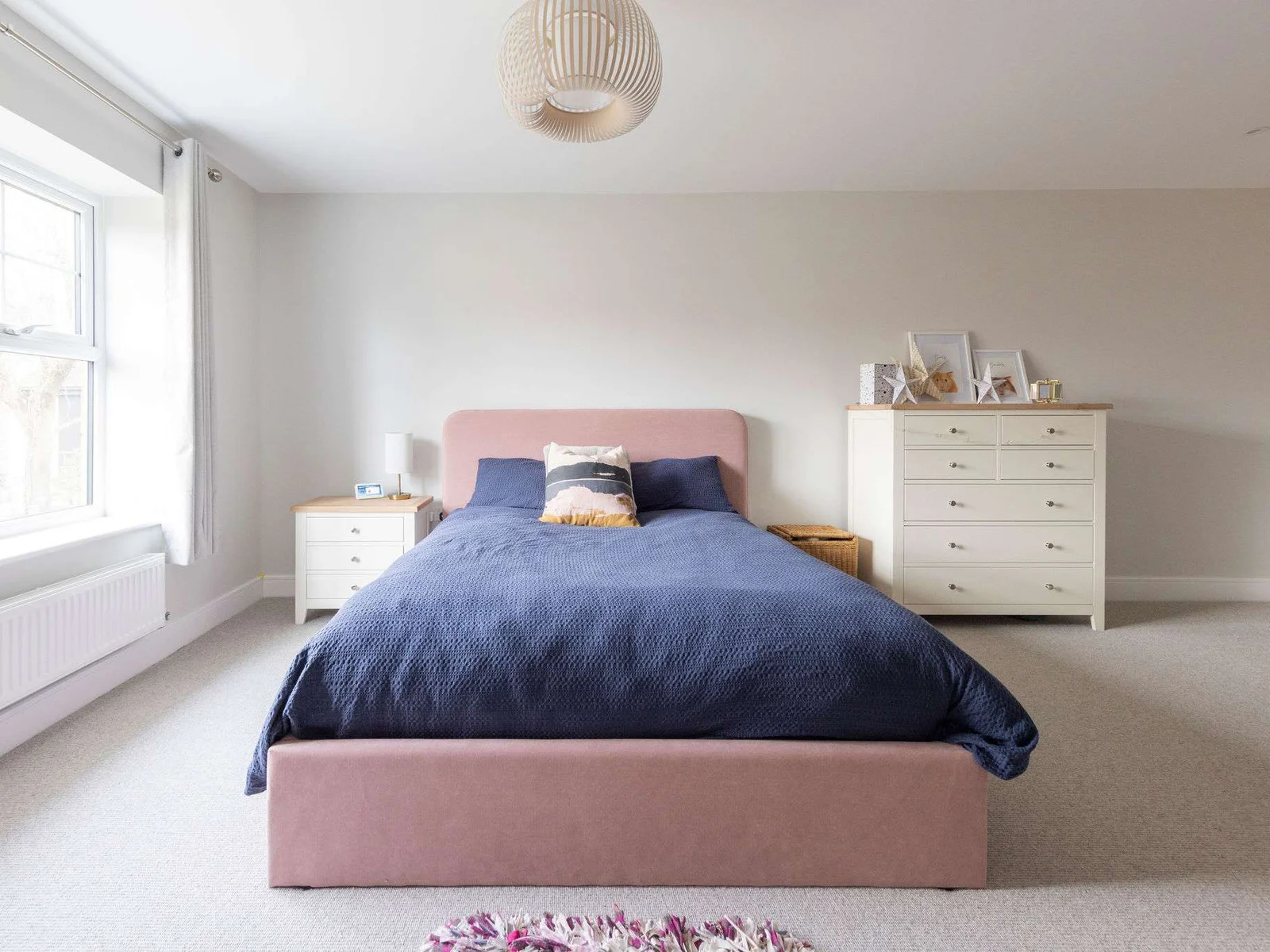 This room is light and airy with large window, check of drawers and bedside table.