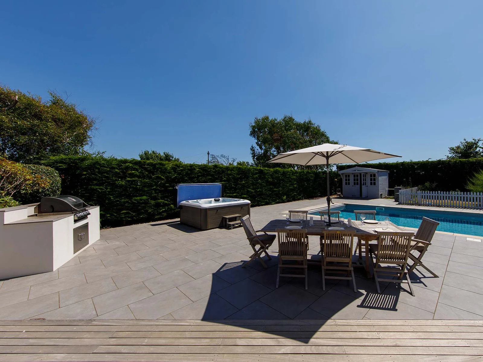 The outside space certainly has the wow factor, with in-built gas BBQ, multiple seating areas, hot tub and pool.
