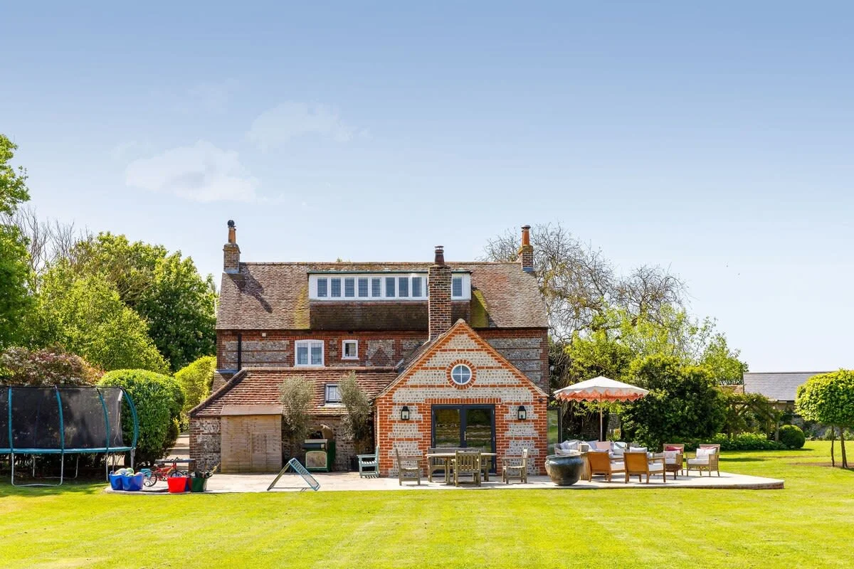 The home has a large rear patio with a beautiful seating area, fire pit and pizza oven. Enjoy an afternoon drink or evening sundowner while the children play on the trampoline and surrounding lawns.