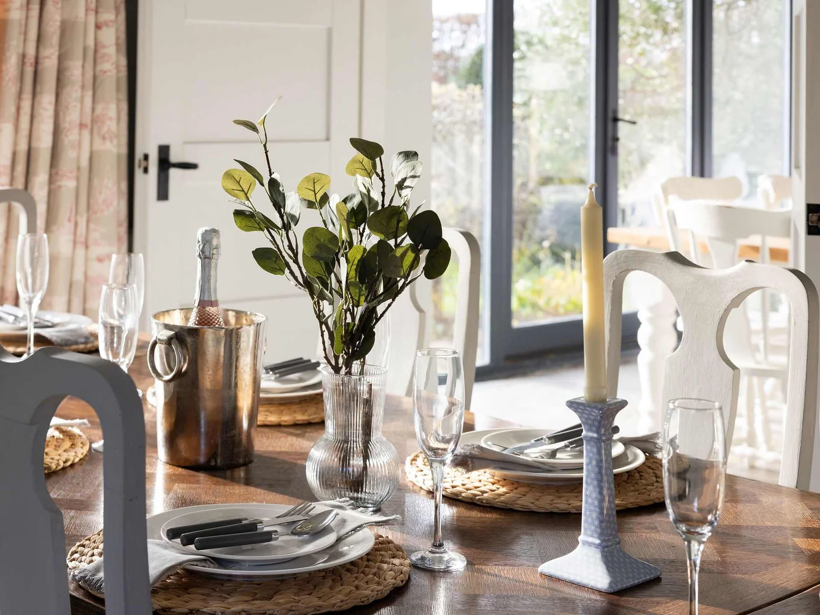 Thoughtfully styled dining space with garden light streaming through.