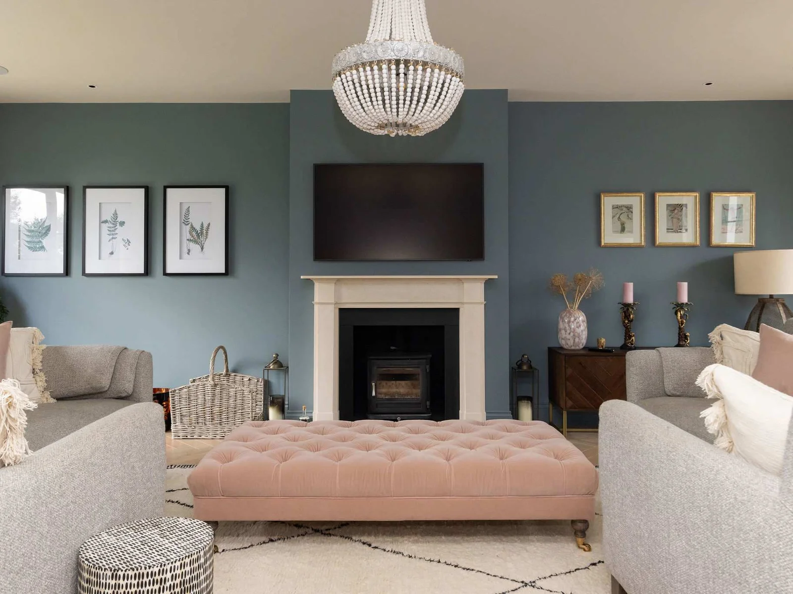Elegant main lounge with cosy fireplace, stylish furnishings, and a serene coastal colour palette.