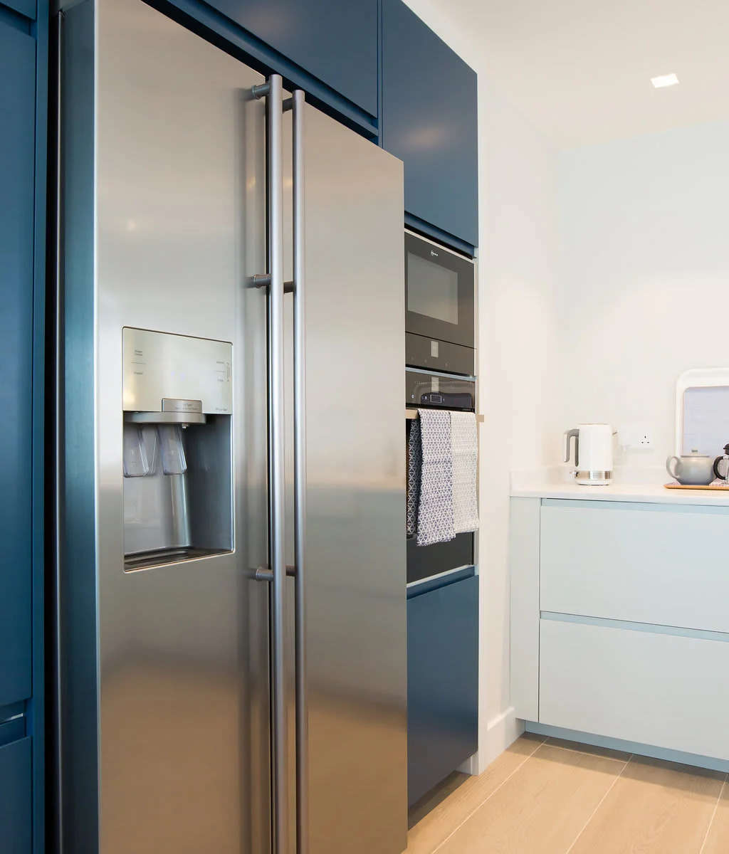 The kitchen features a large American style fridge freezer.
