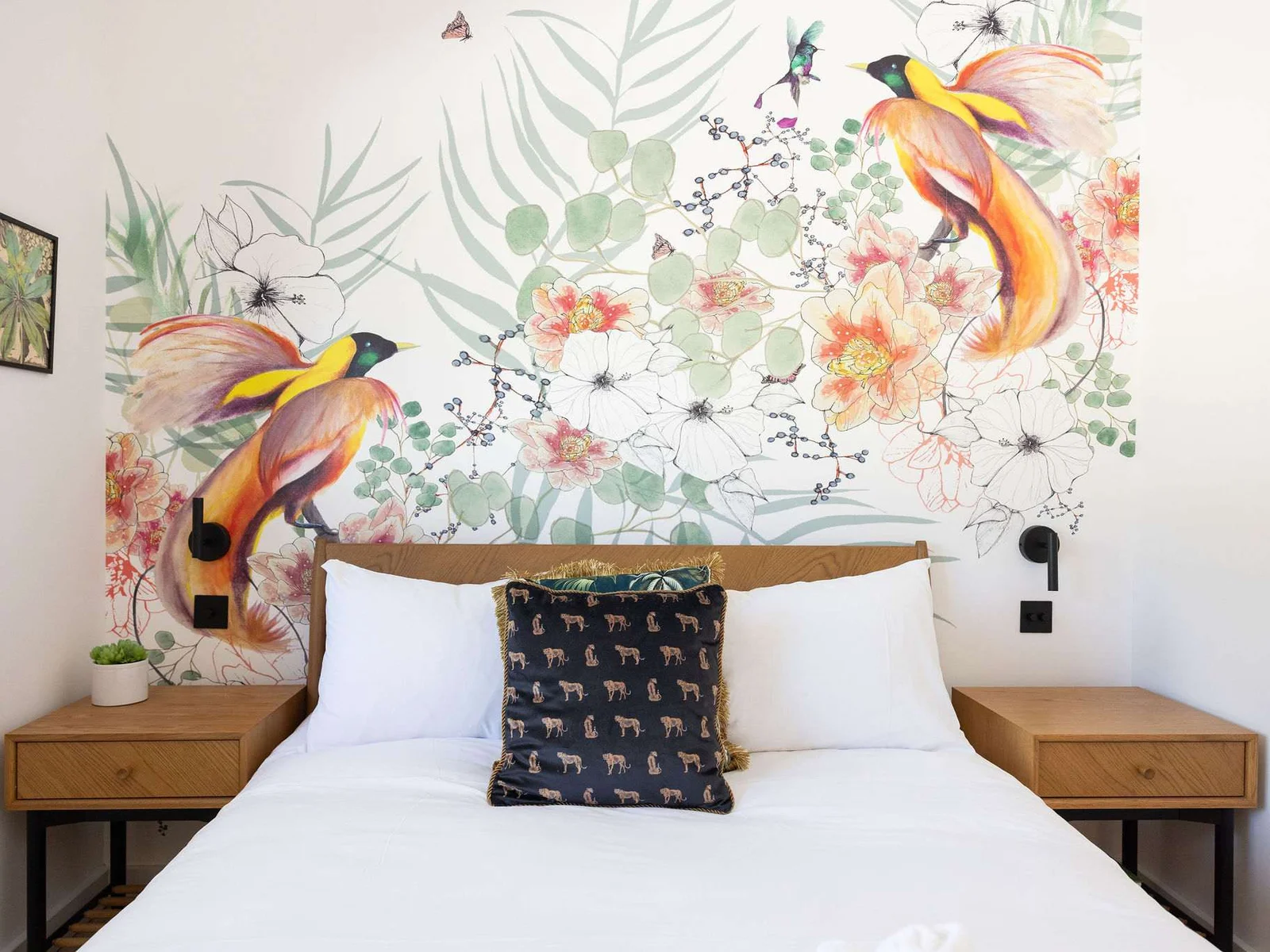 Settle into a peaceful king bedroom with playful botanical wallpaper, cosy touches, and easy Sussex comfort.
