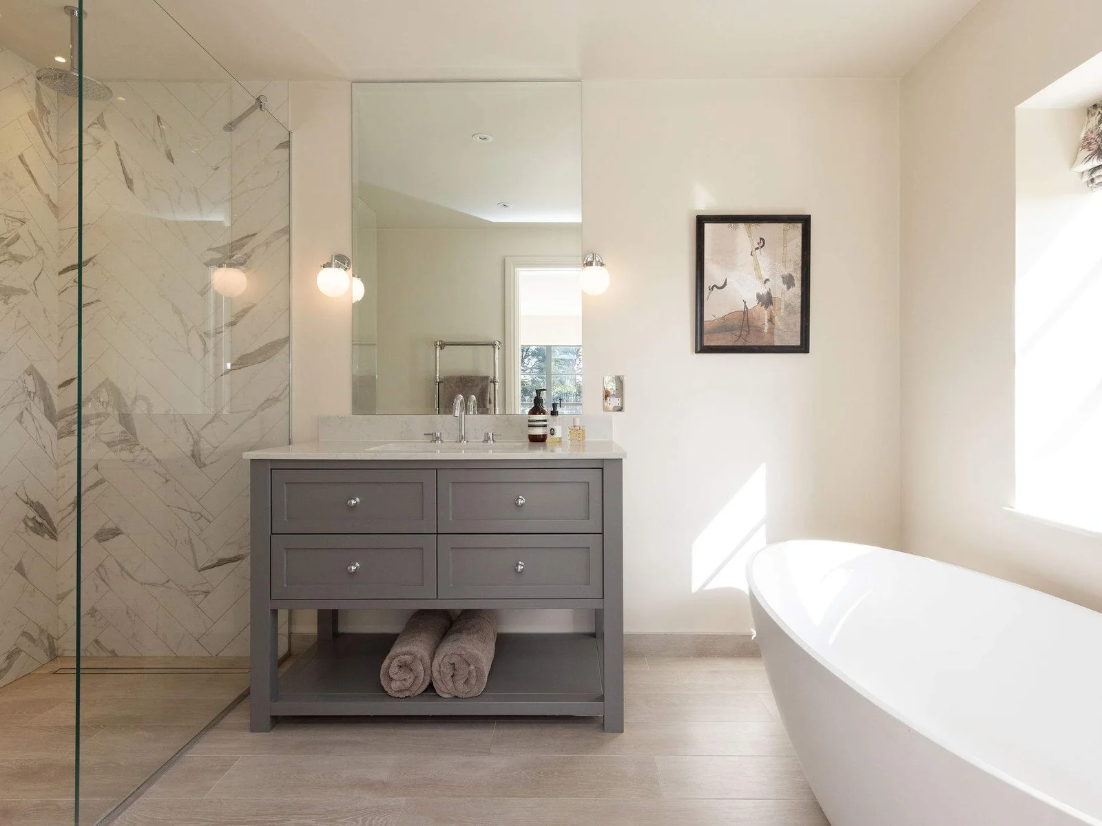 Spa-inspired bathroom featuring a freestanding bath, walk-in shower, and elegant contemporary finishes.