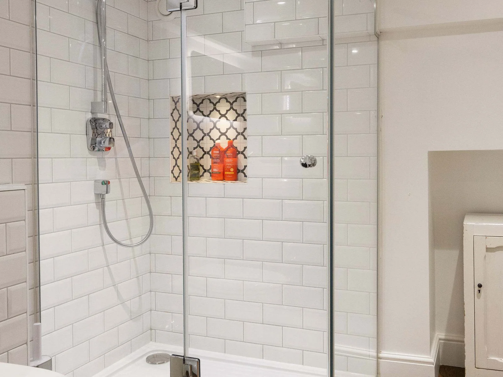 Spacious rainfall shower with elegant tiled finish