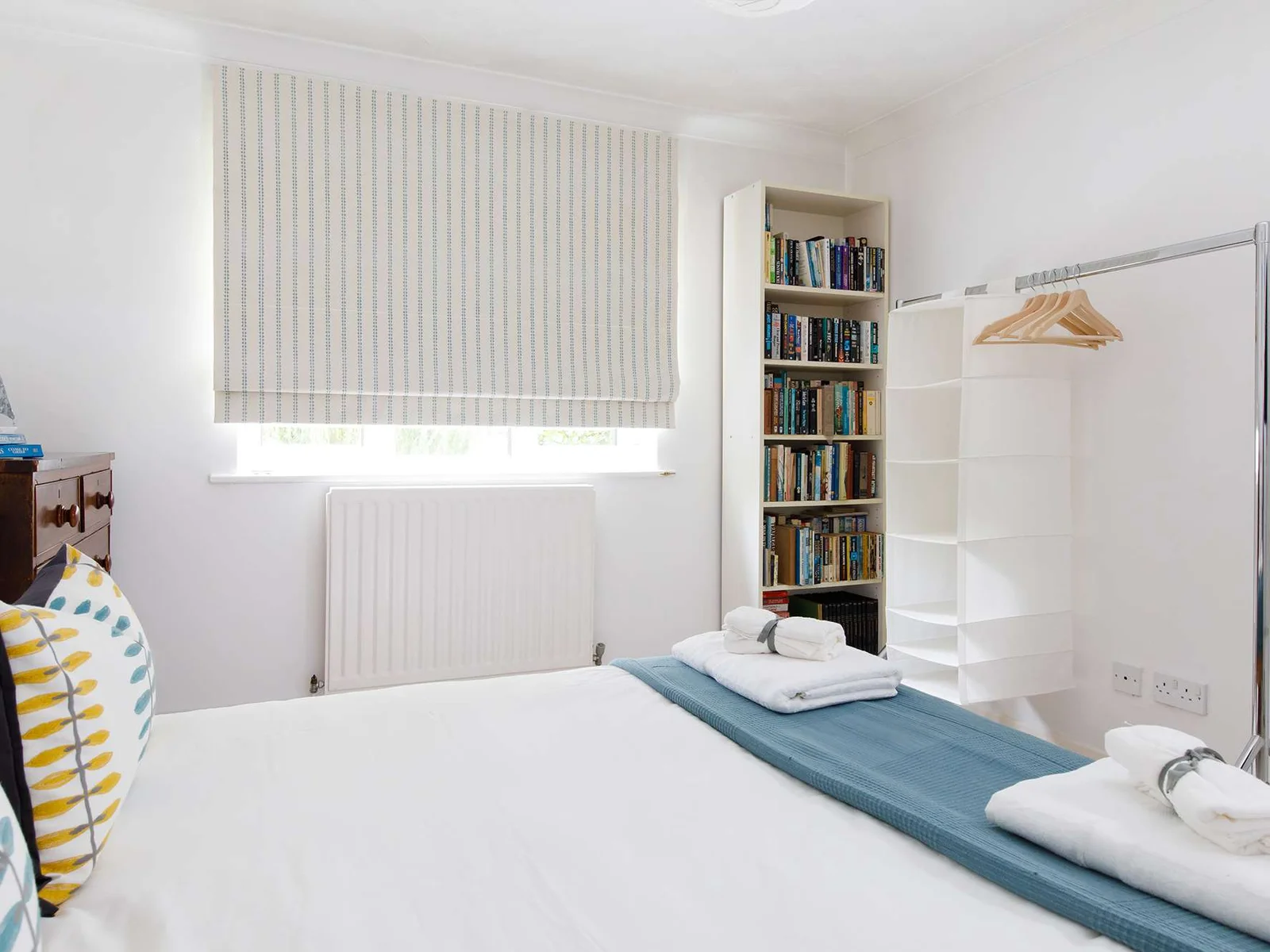 The second room downstairs has a king bed and plenty of reading material.