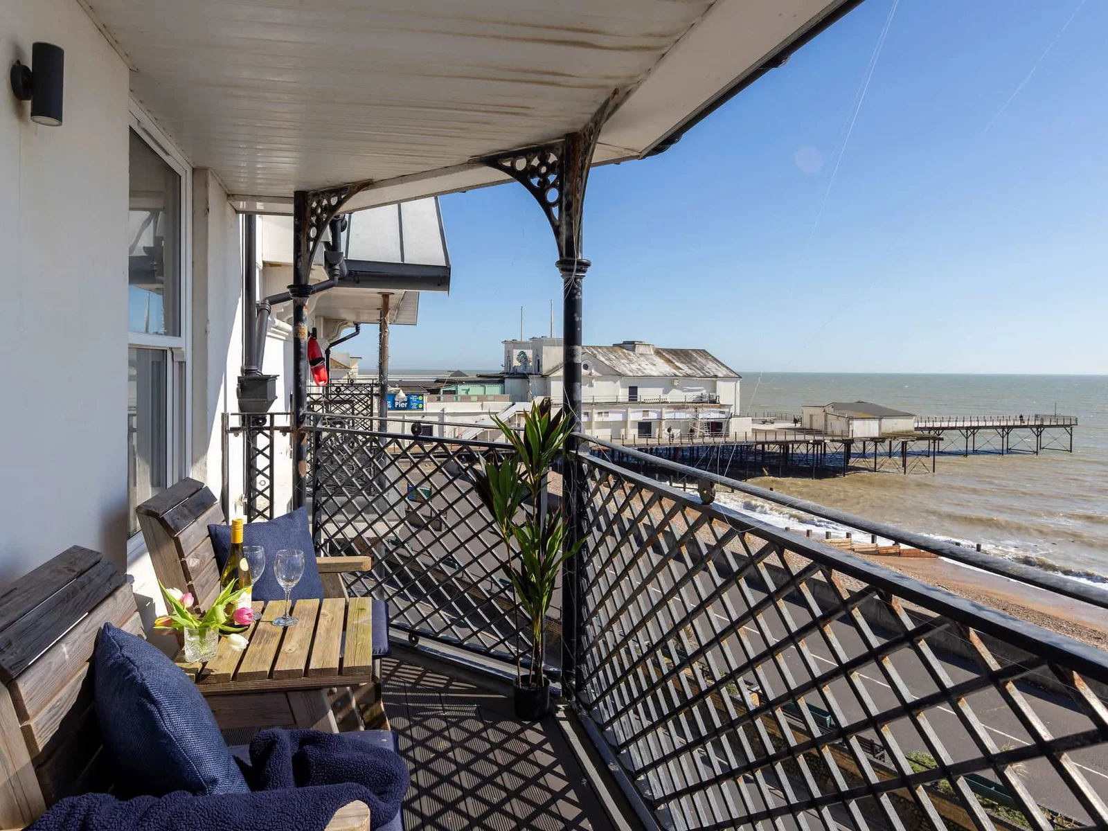 The private balcony offers a standout seafront setting with panoramic views across the coast.