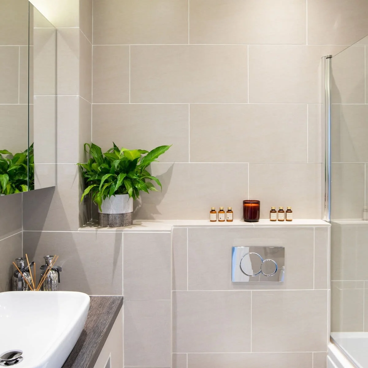 Main bathroom has a bath with overhead shower, WC, vanity sink and mirror. Perfect for getting ready for an evening out.