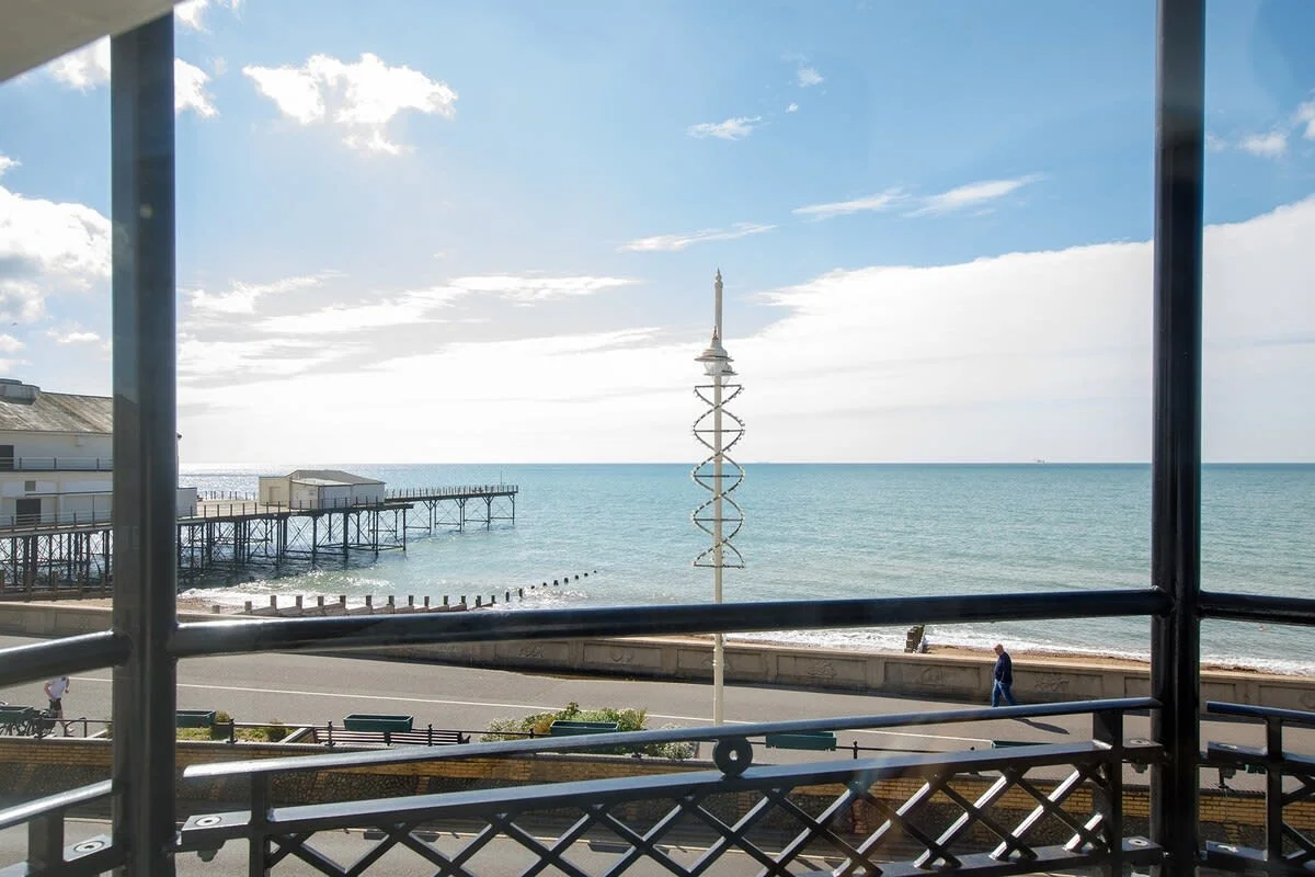 Panoramic sea views and a prime seafront setting make this stylish apartment a relaxing coastal escape.