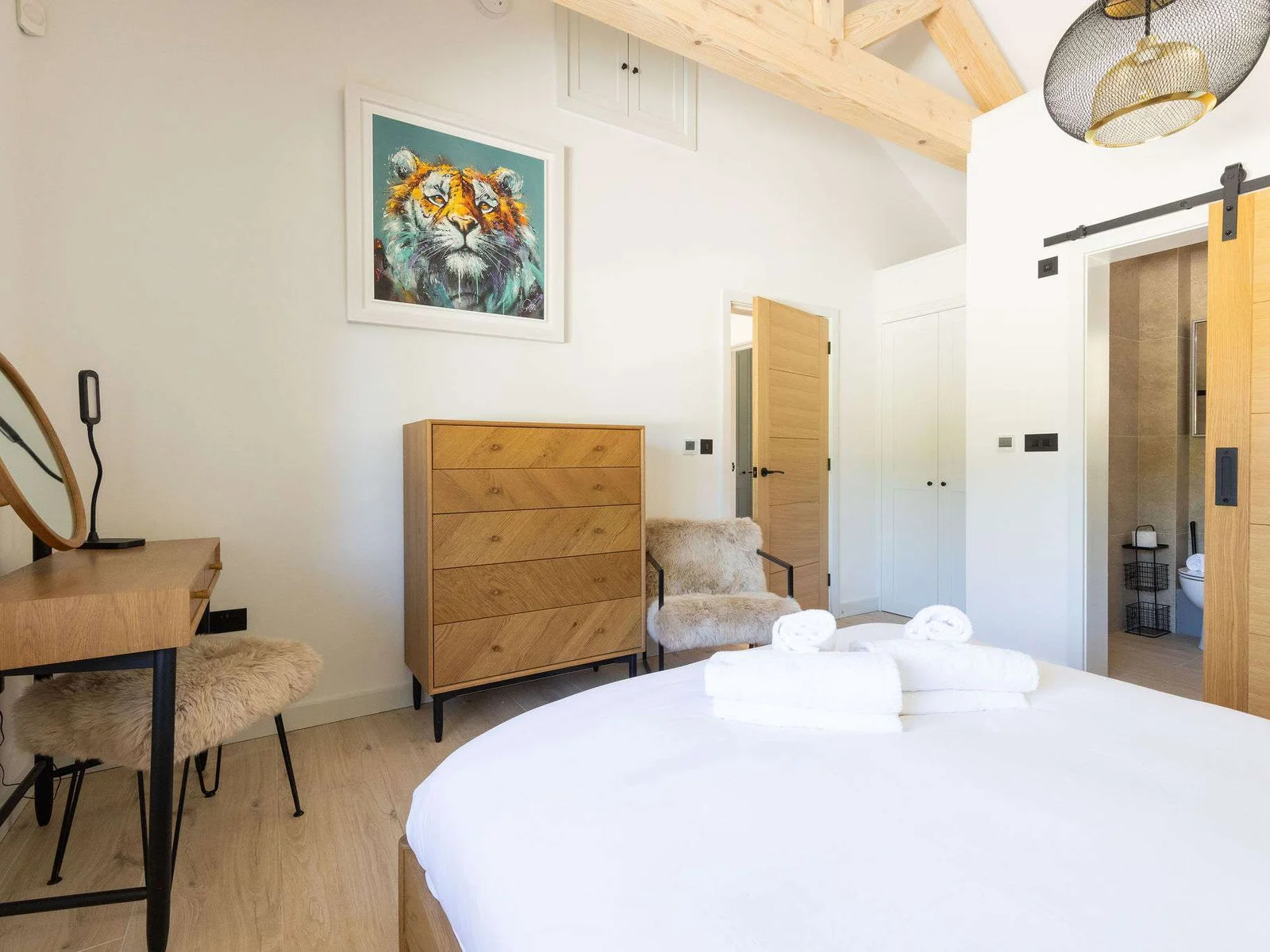 Wake up slowly in a calm bedroom with rustic touches, soft light, and relaxed lodge comfort.