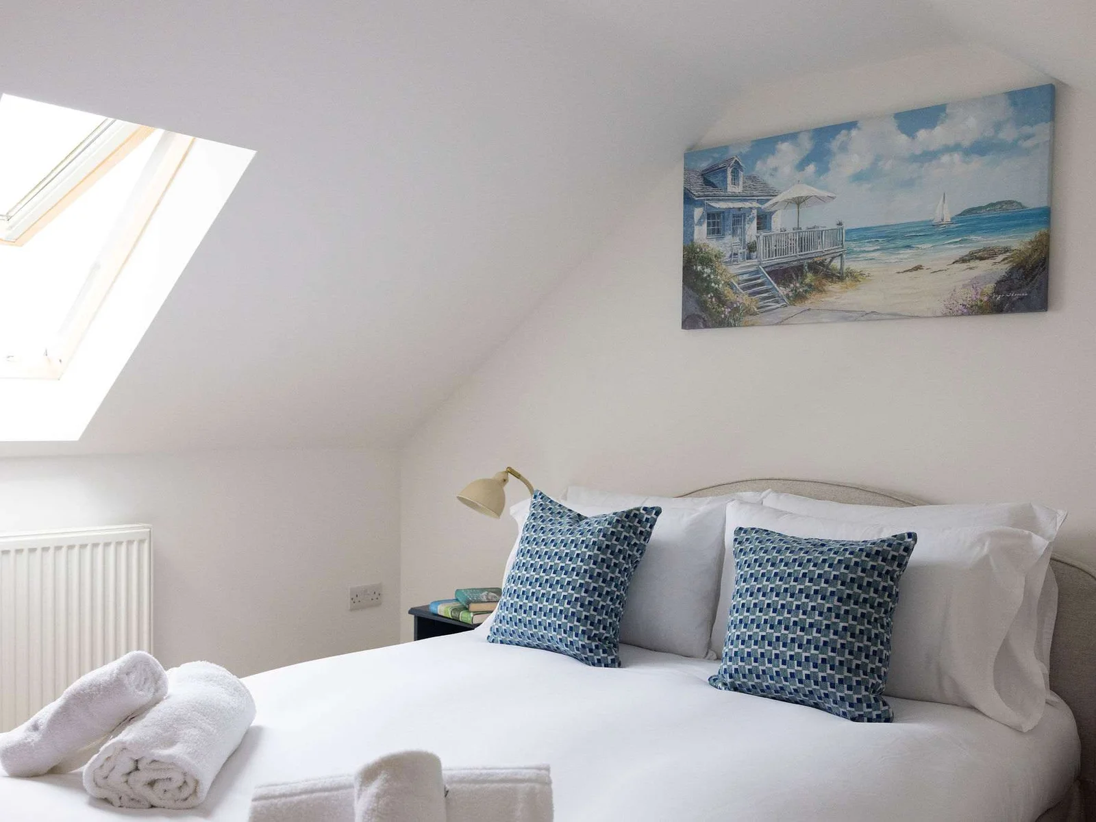 Another view of the first top-floor double, where the skylight brings in plenty of natural light and adds to the cosy, tucked-away feel.