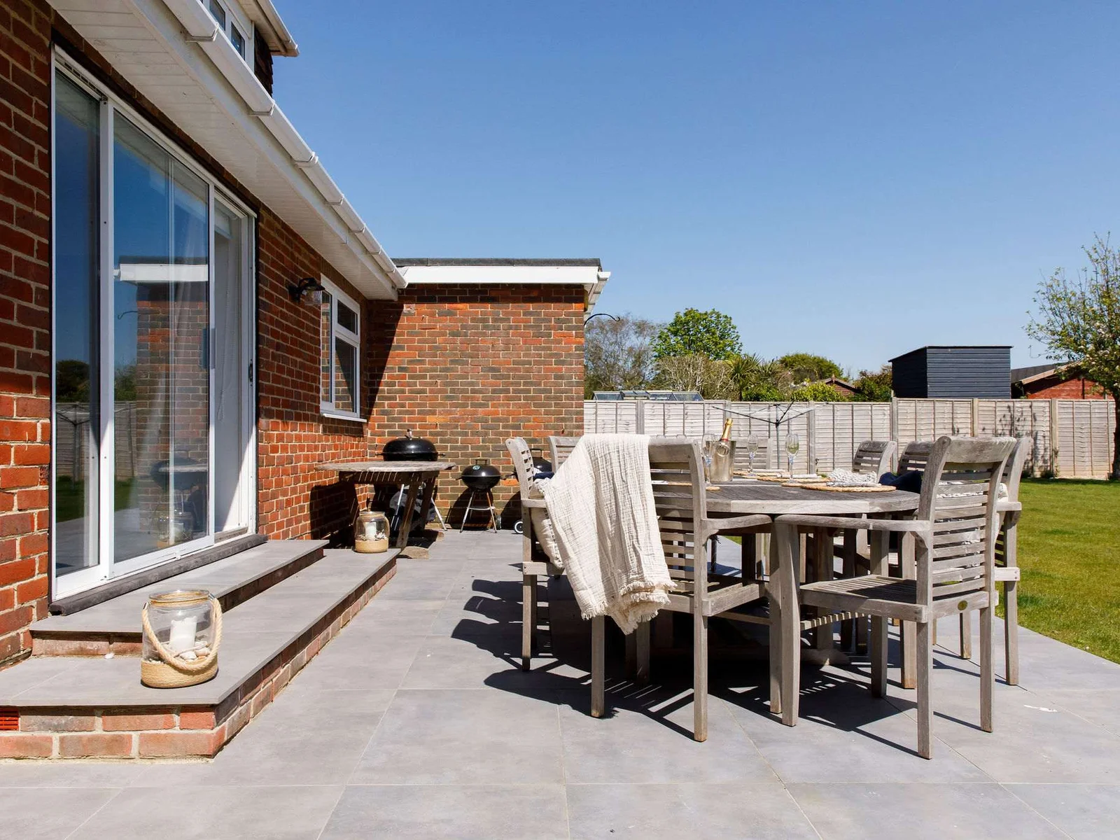 Enjoy meals or drinks on the comfortable patio, overlooking the large garden.