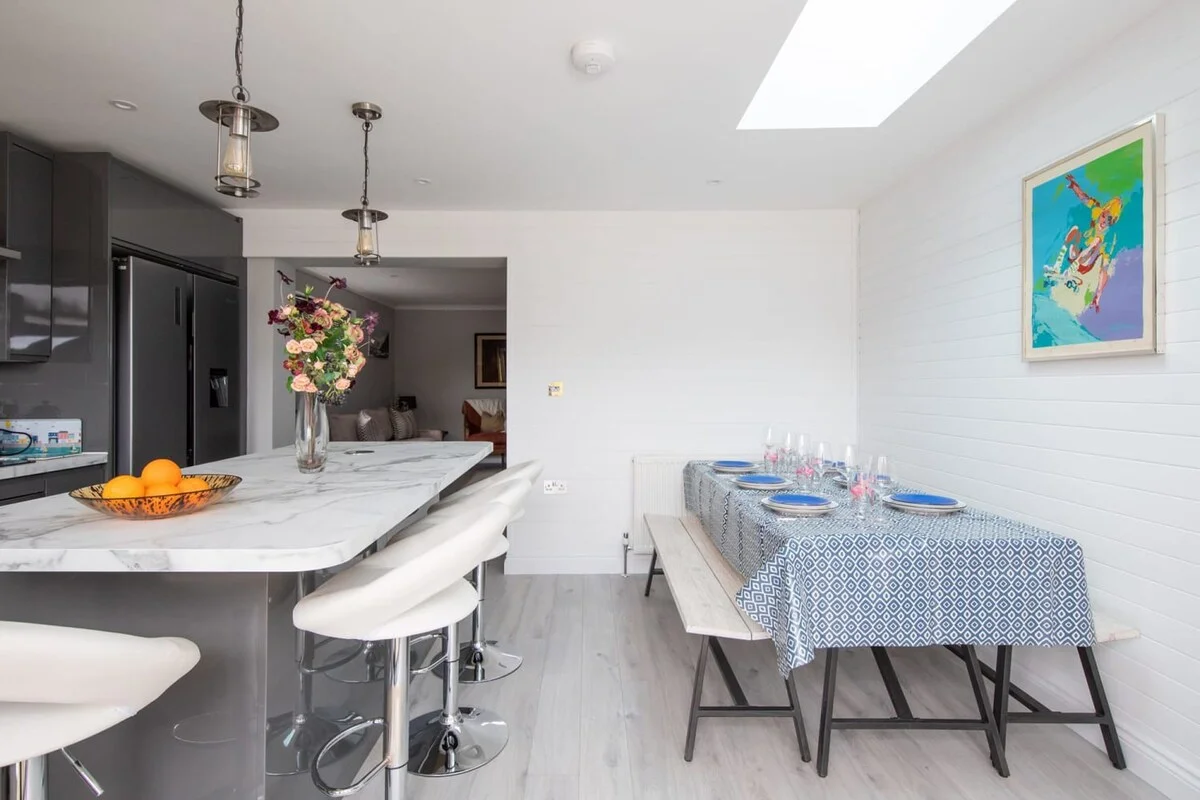 The living room opens up into the fully equipped kitchen with the dining area.