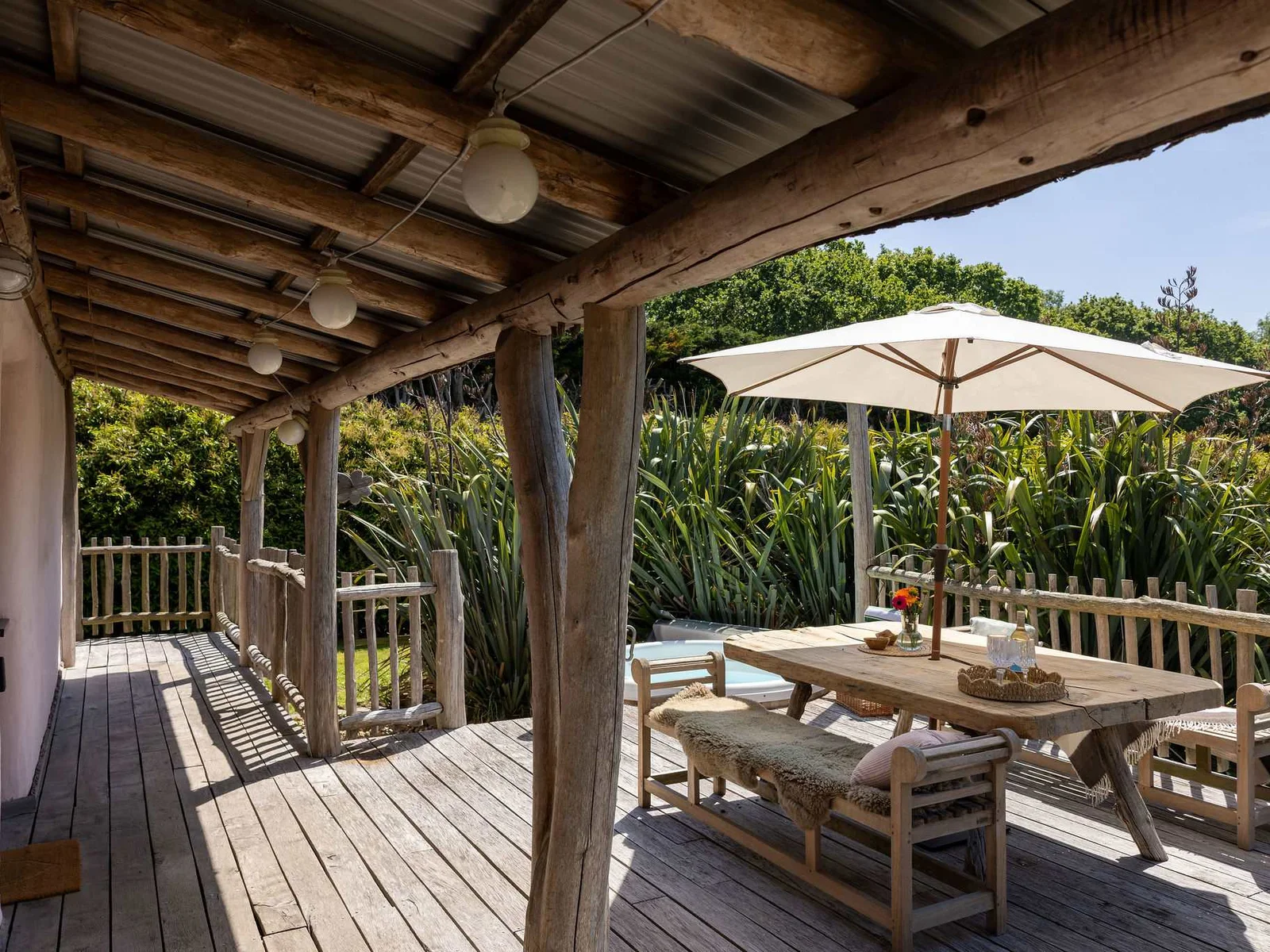 Dine al fresco beneath rustic timber beams — countryside living at its most relaxed.