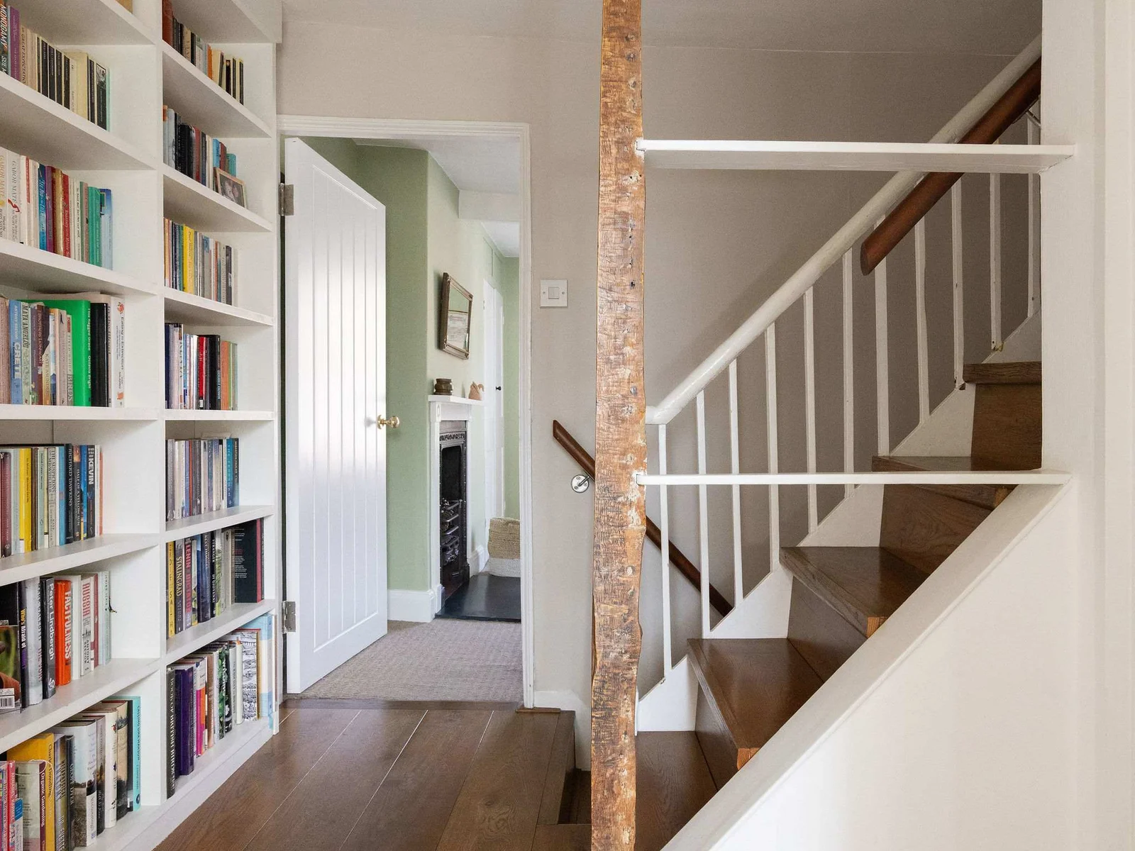 Characterful landing with exposed beams and built-in bookshelves