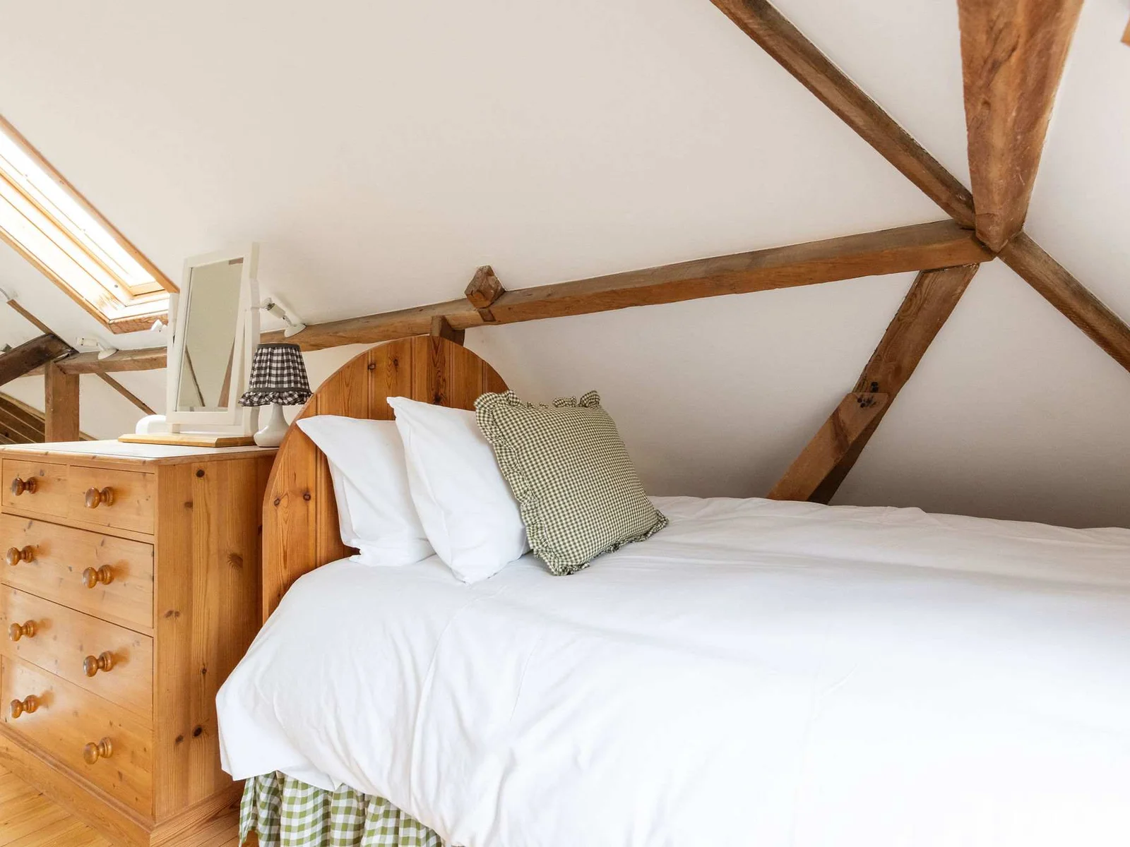 Drift off beneath original timber beams in the cosy mezzanine twin bedroom.