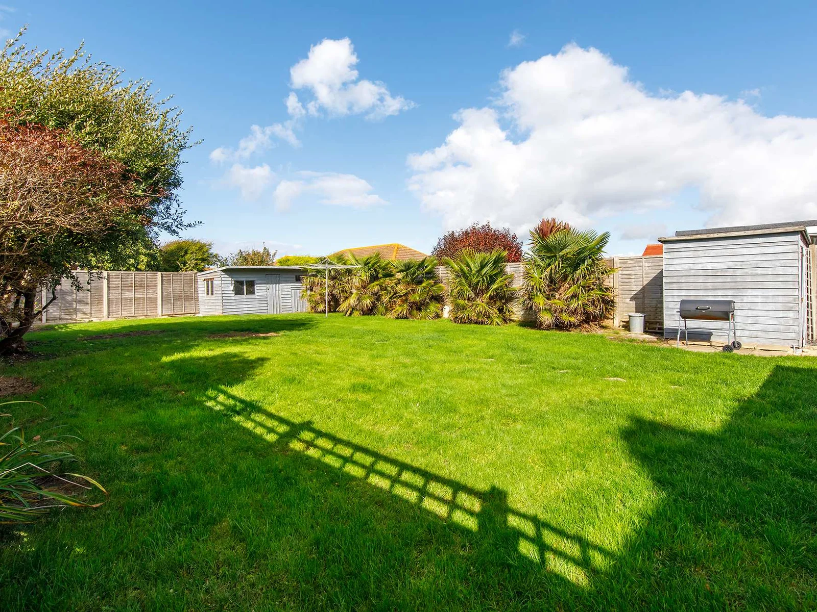 Relax in the lush green garden with a BBQ or cold drink.