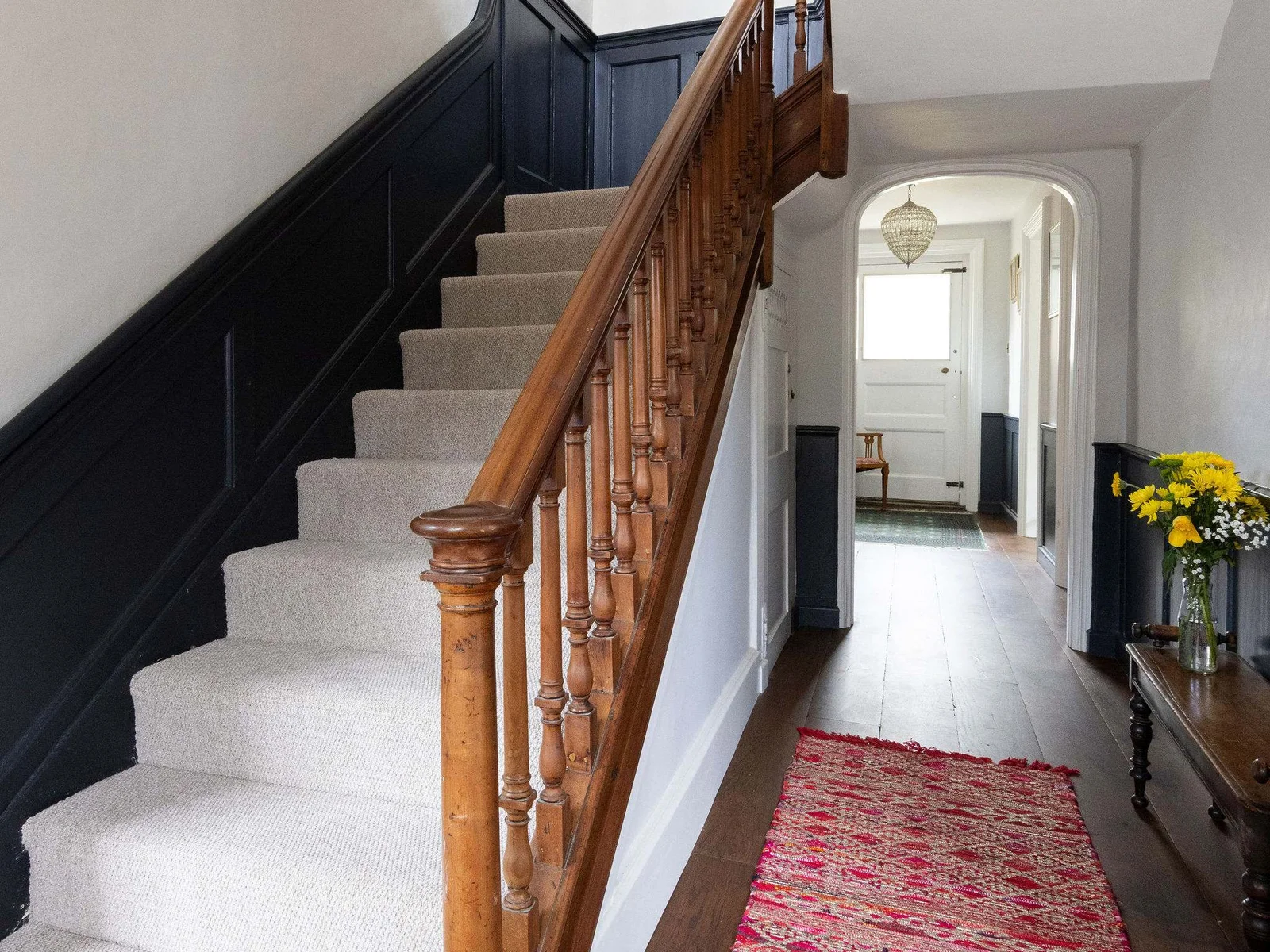Stylish hallway with wooden banisters and timeless panelling