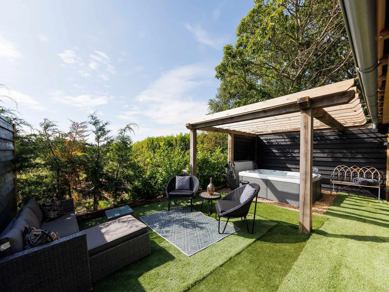 The superb outdoor space has plenty of places to sit. Not to mention the hot tub!