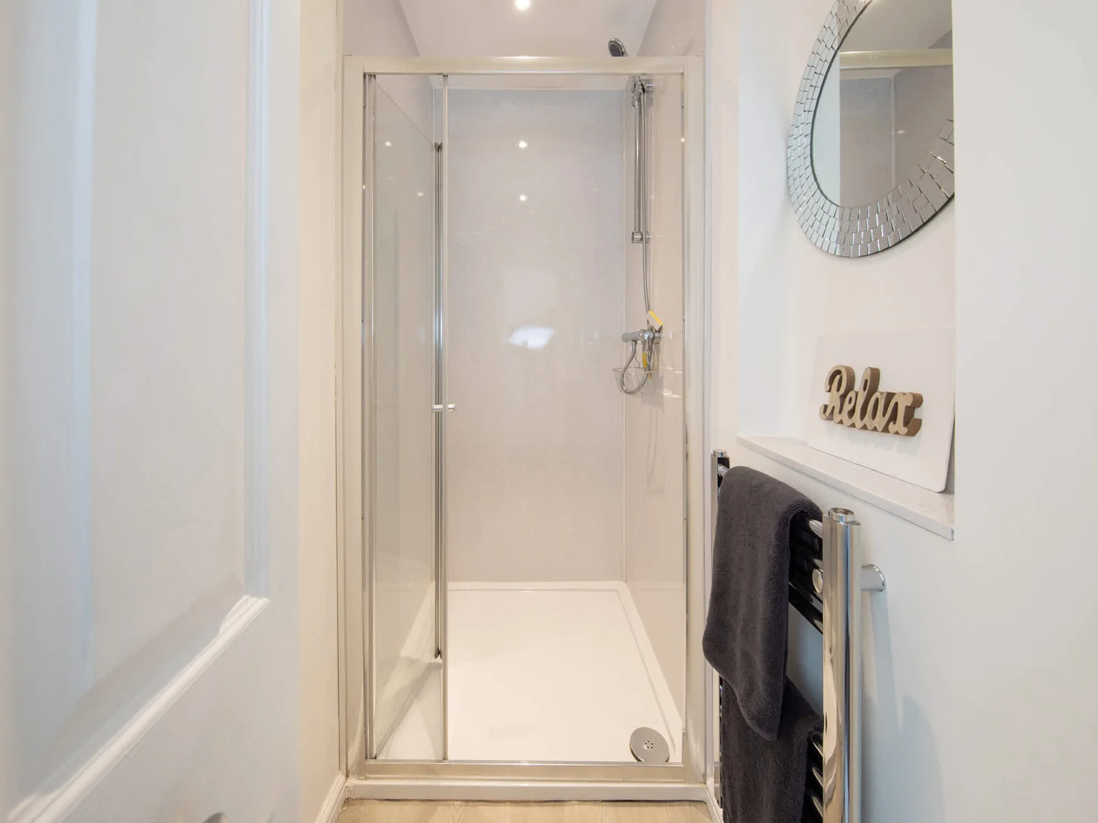 The sparkling shower room with a heated towel rail