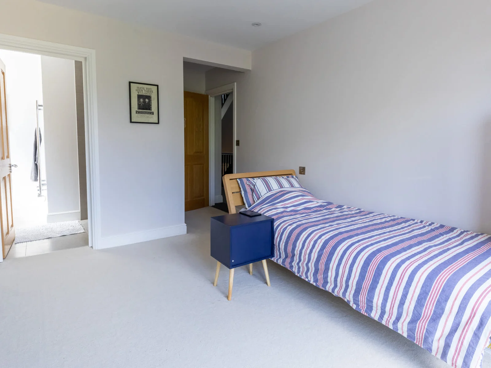 Spacious single bedroom with ensuite access, ideal for families or group stays.