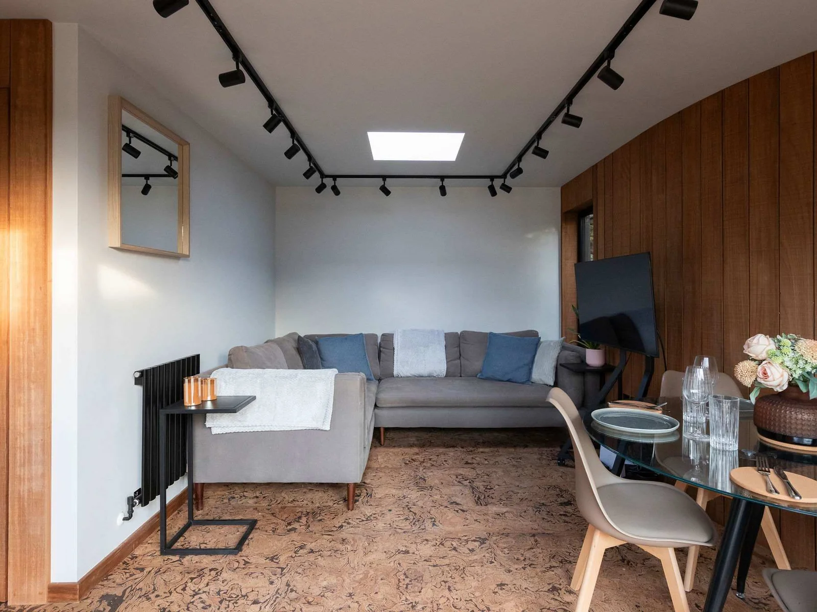 The main living space is bright and airy, offering a stylish base to retreat to after a day at the beach or exploring the area.